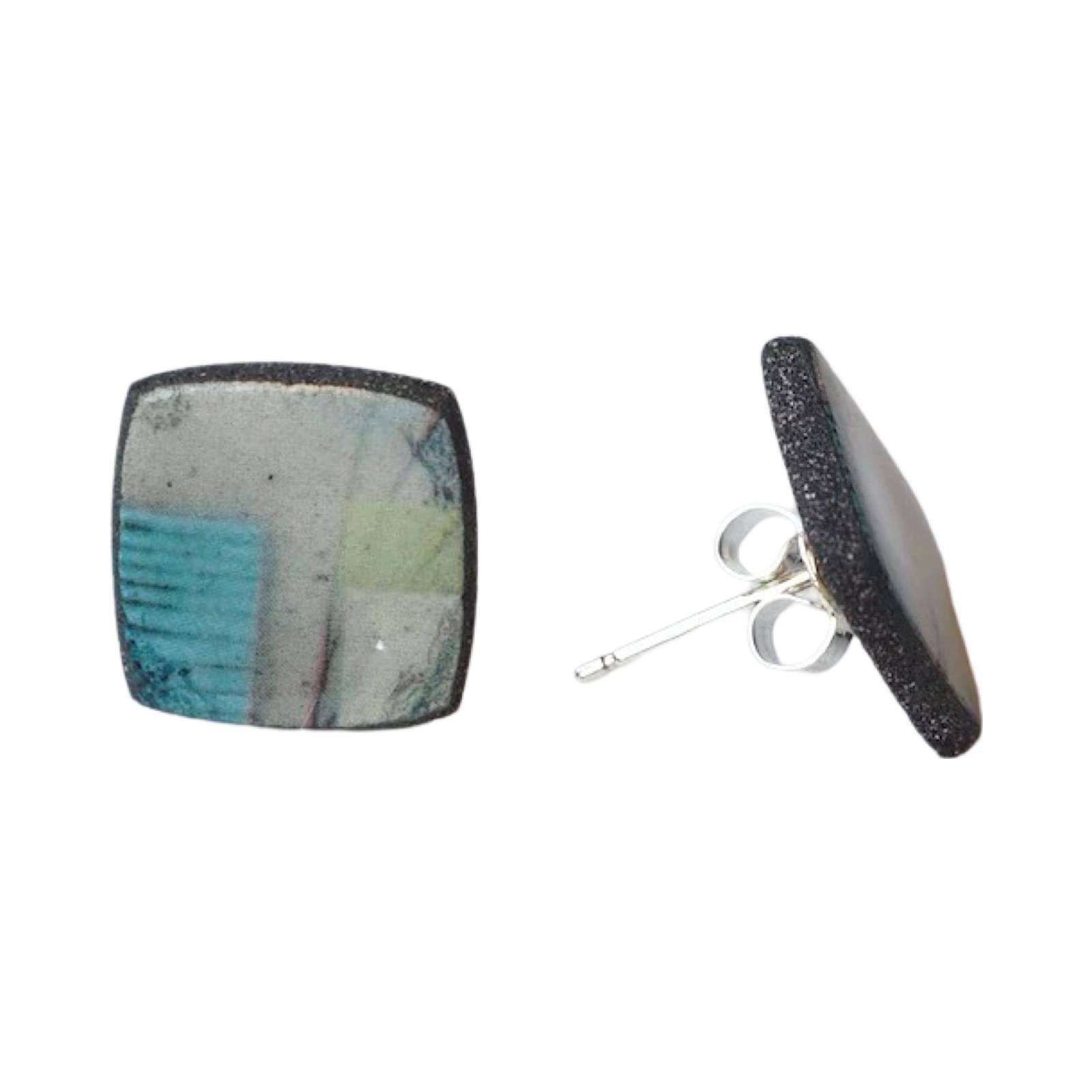 These porcelain square stud earrings are made from black porcelain casting slip layered with a white decorating slip and a ceramic decal.