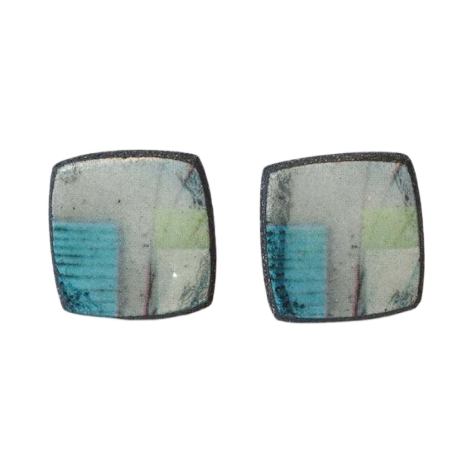 These porcelain square stud earrings are made from black porcelain casting slip layered with a white decorating slip and a ceramic decal.