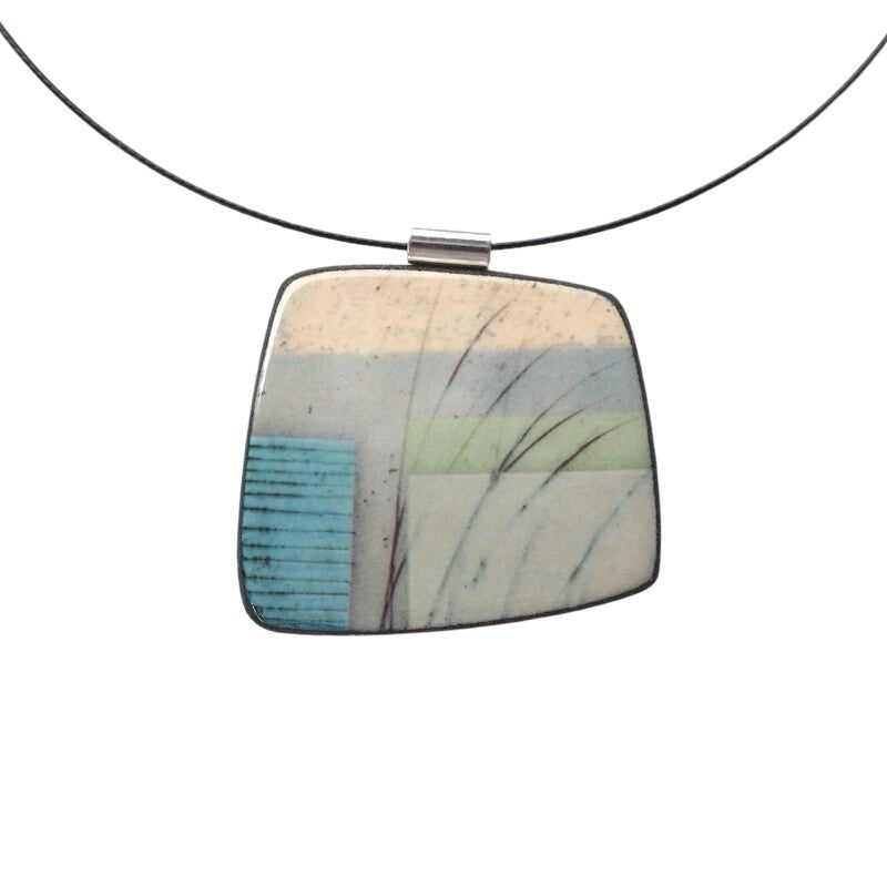 This pendent necklace is made from black porcelain casting slip layered with a white decorating slip and a ceramic decal, it is a wearable piece of art! The brooch features a turquoise, grey and cream abstract pattern, inspired by nature.
