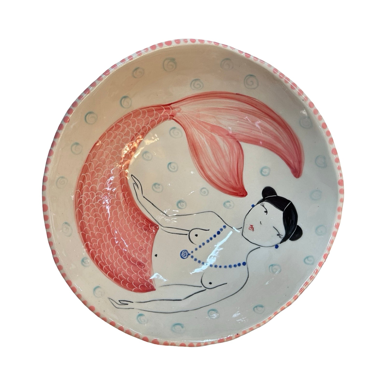Ceramic plate with a mermaid design on a white background.