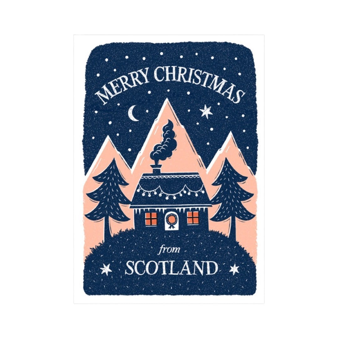 Christmas card featuring a cabin in the forest with smoke rising from the cosy fire inside and the text ' Merry Christmas from Scotland'. All on a navy background with pale pink mountains in the centre and a white border.