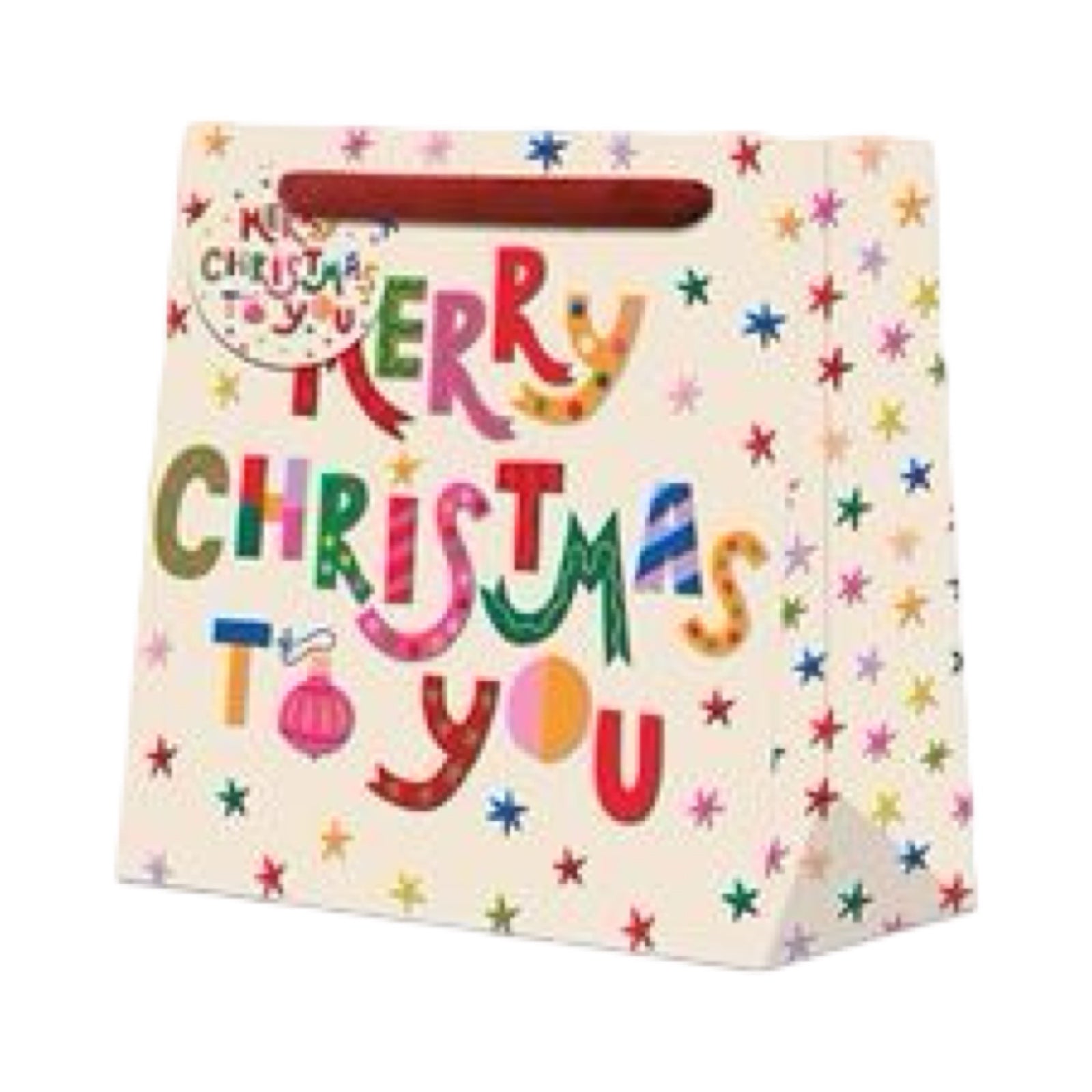 Christmas gift bag featuring teh text 'Merry Christmas to You' in multicoloured lettering against a cream background with bright colourful stars. Each bag comes with red ribbon handles and a matching gift tag.