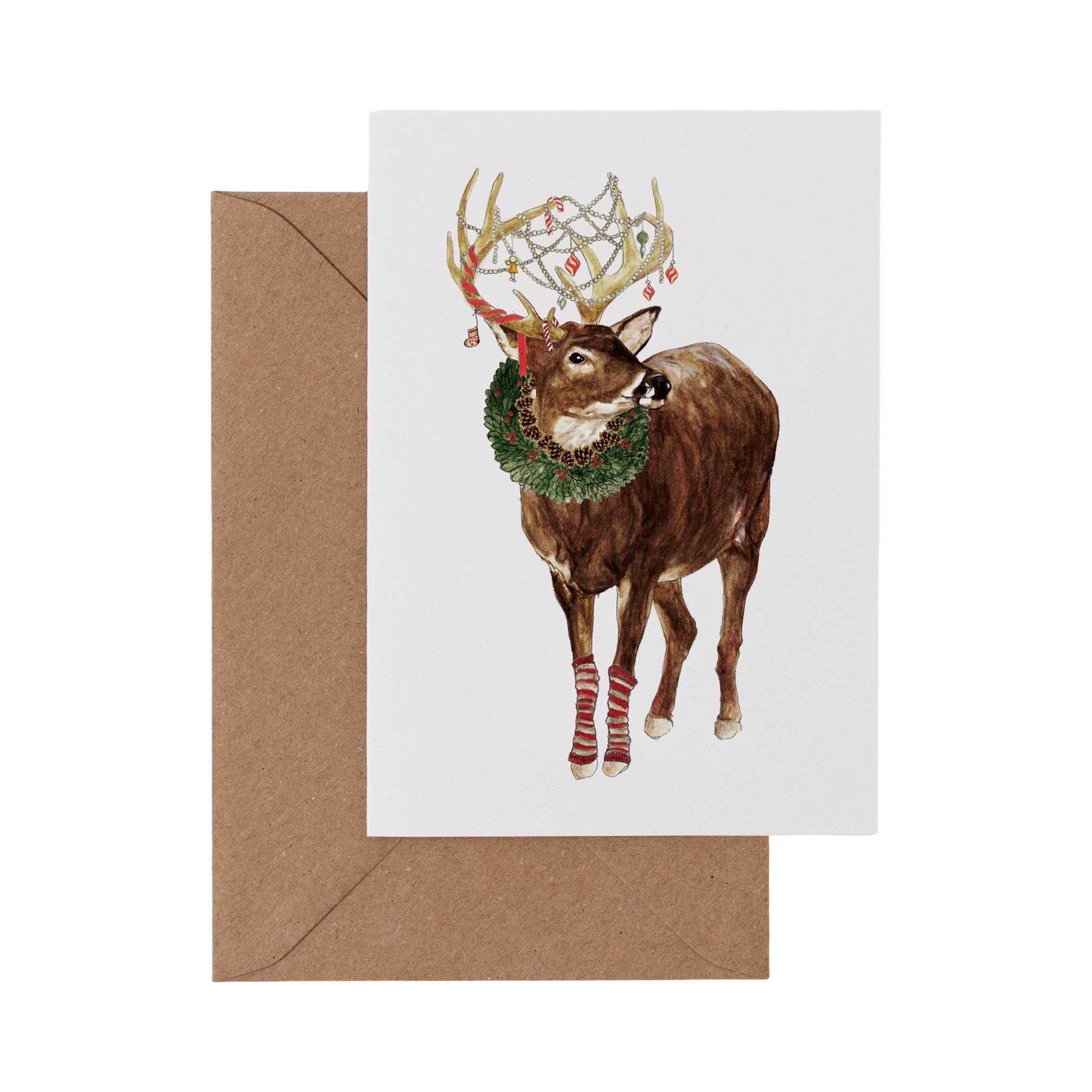 Greeting card with a deer wearing a wreath and antlers, accompanied by a brown envelope.