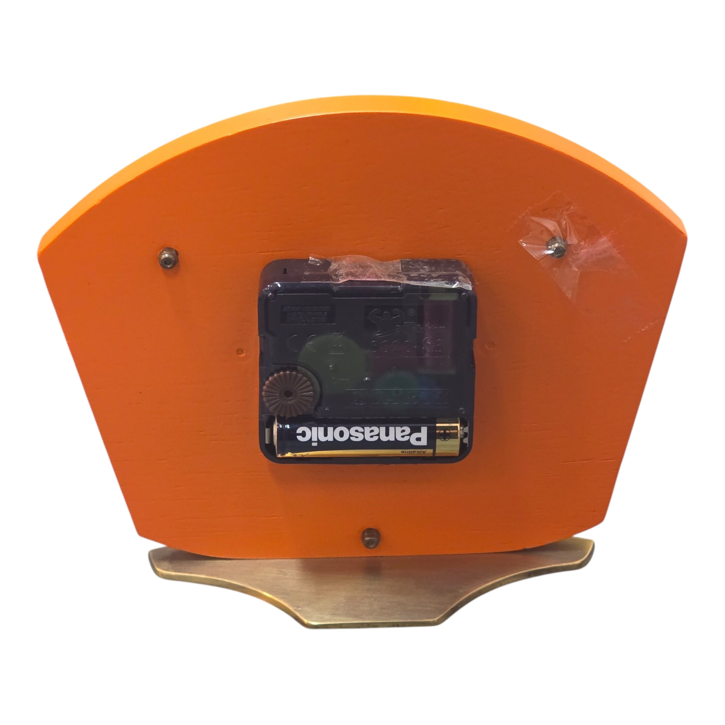 The back of an orange clock 