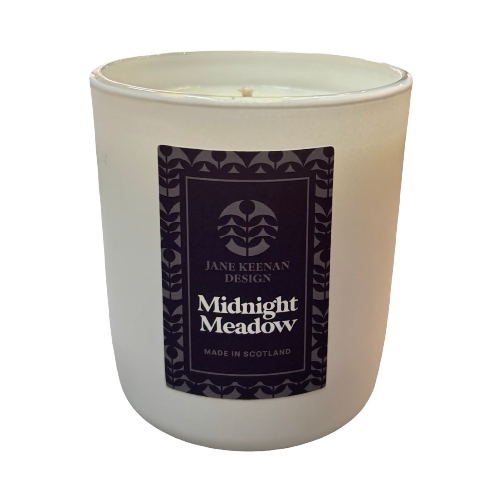 A white glass jar candle with a dark navy label reading 'Midnight Meadow' by Jane Keenan Design, shown on a plain white background.