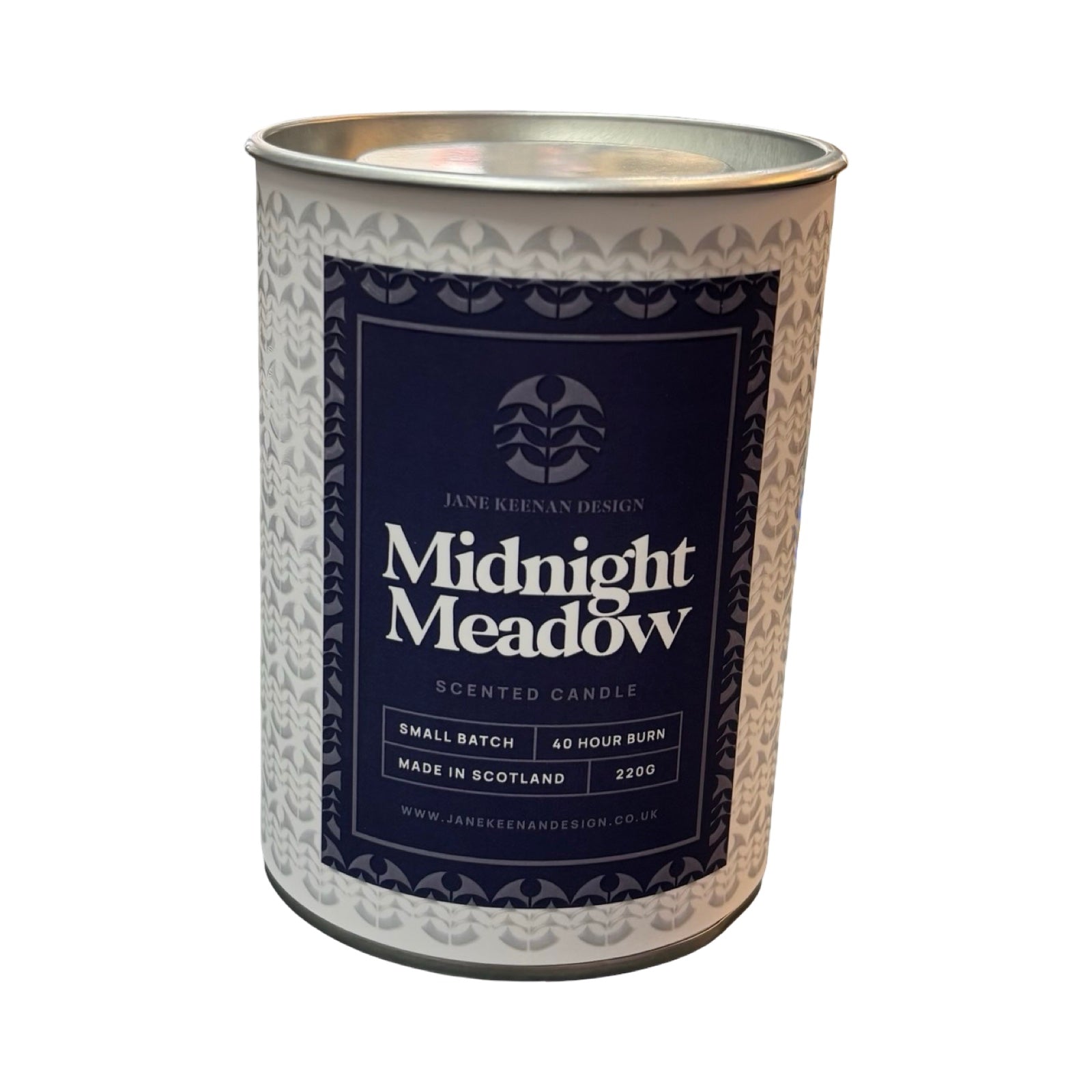 A cylindrical metal candle tin for 'Midnight Meadow' scented candle by Jane Keenan Design, featuring a dark navy blue label with white text and a silver patterned tin body, set against a plain white background.