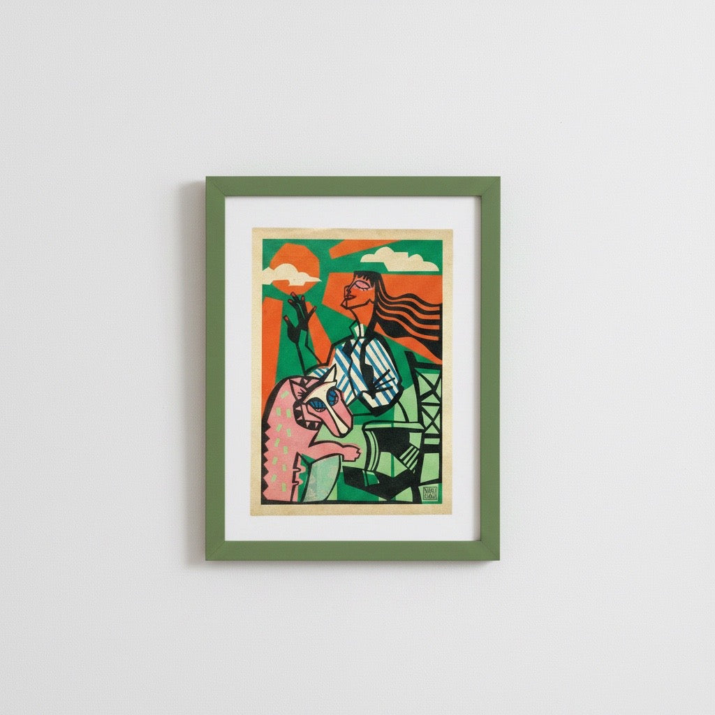 A framed art print featuring a stylised illustration of a woman riding a horse, mounted on a white wall. The print has a green frame, a white mat, and a colourful illustration with orange, green, pink, and blue tones.