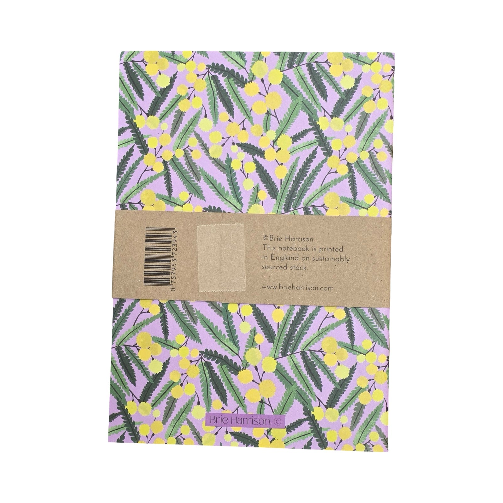 Notebook with floral design and brown band on a white background.