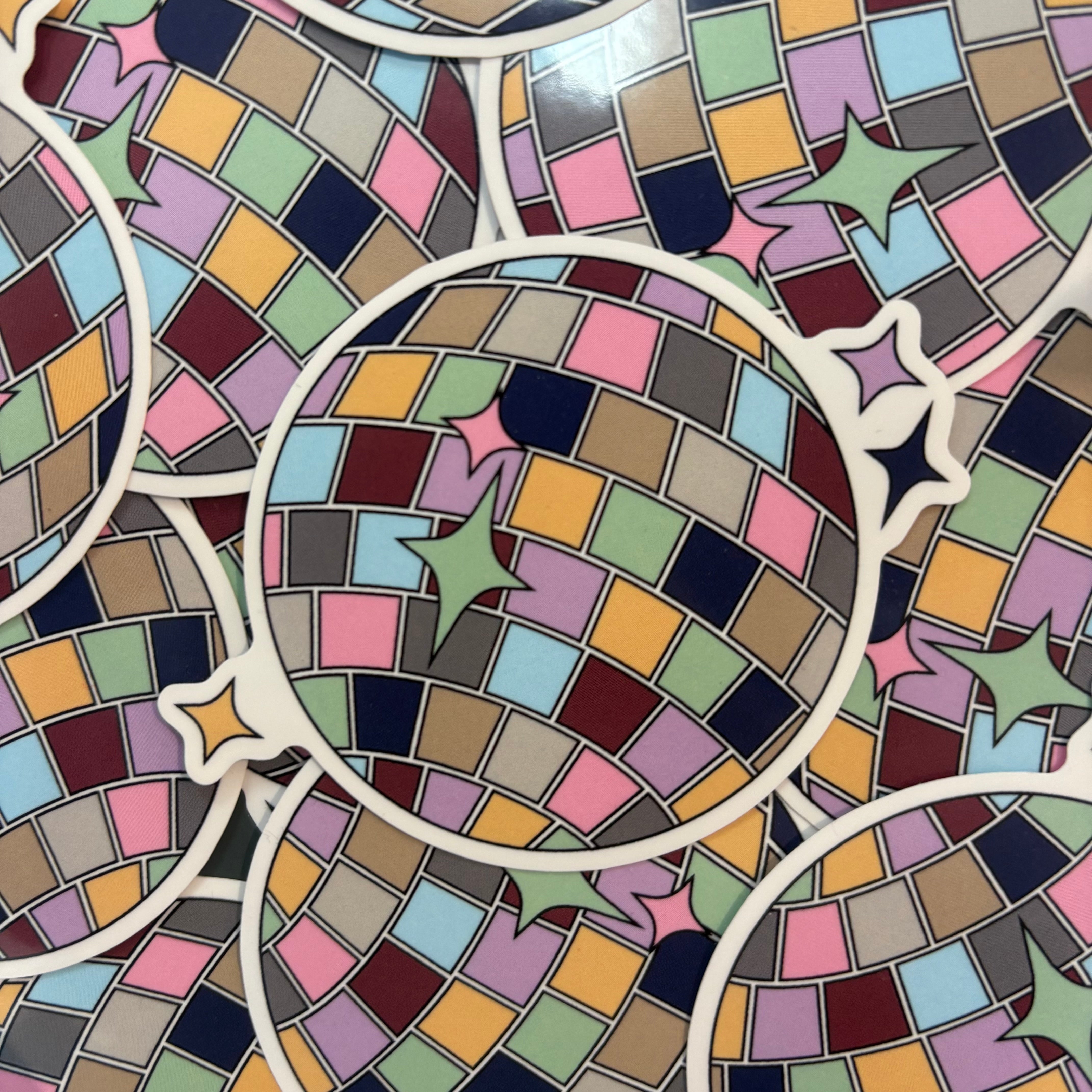 Pile of colourful mirrorball stickers.