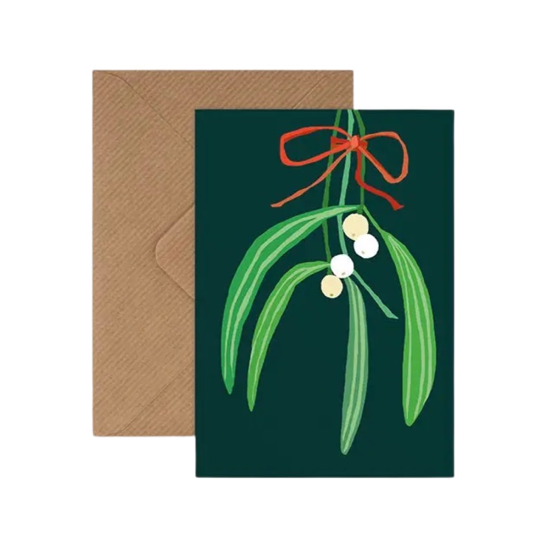 Christmas card with mistletoe on a green background and a kraft brown envelope.