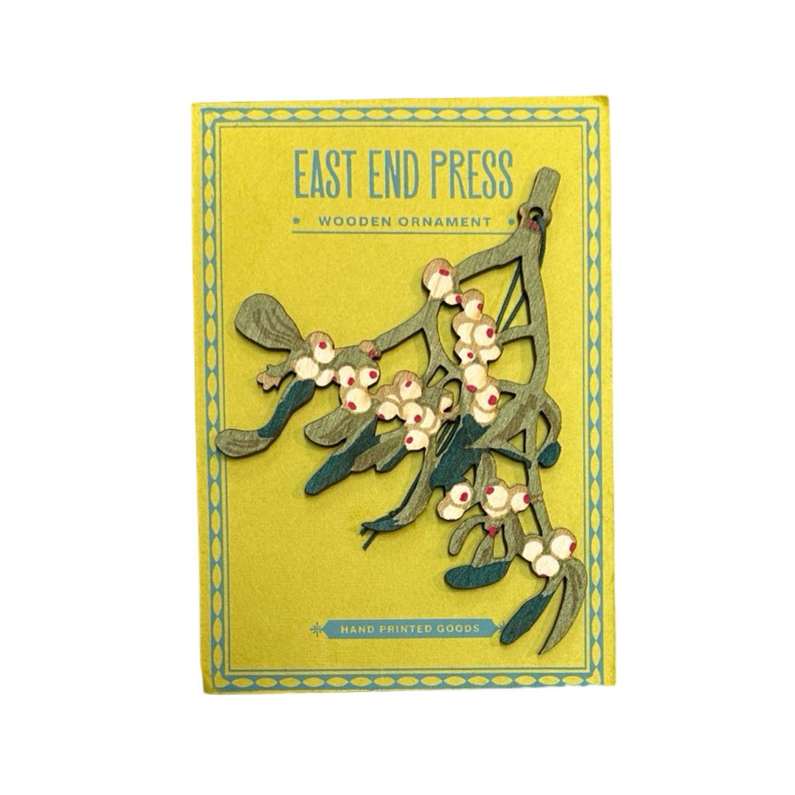 Wooden mistletoe Christmas decoration on yellow backing card