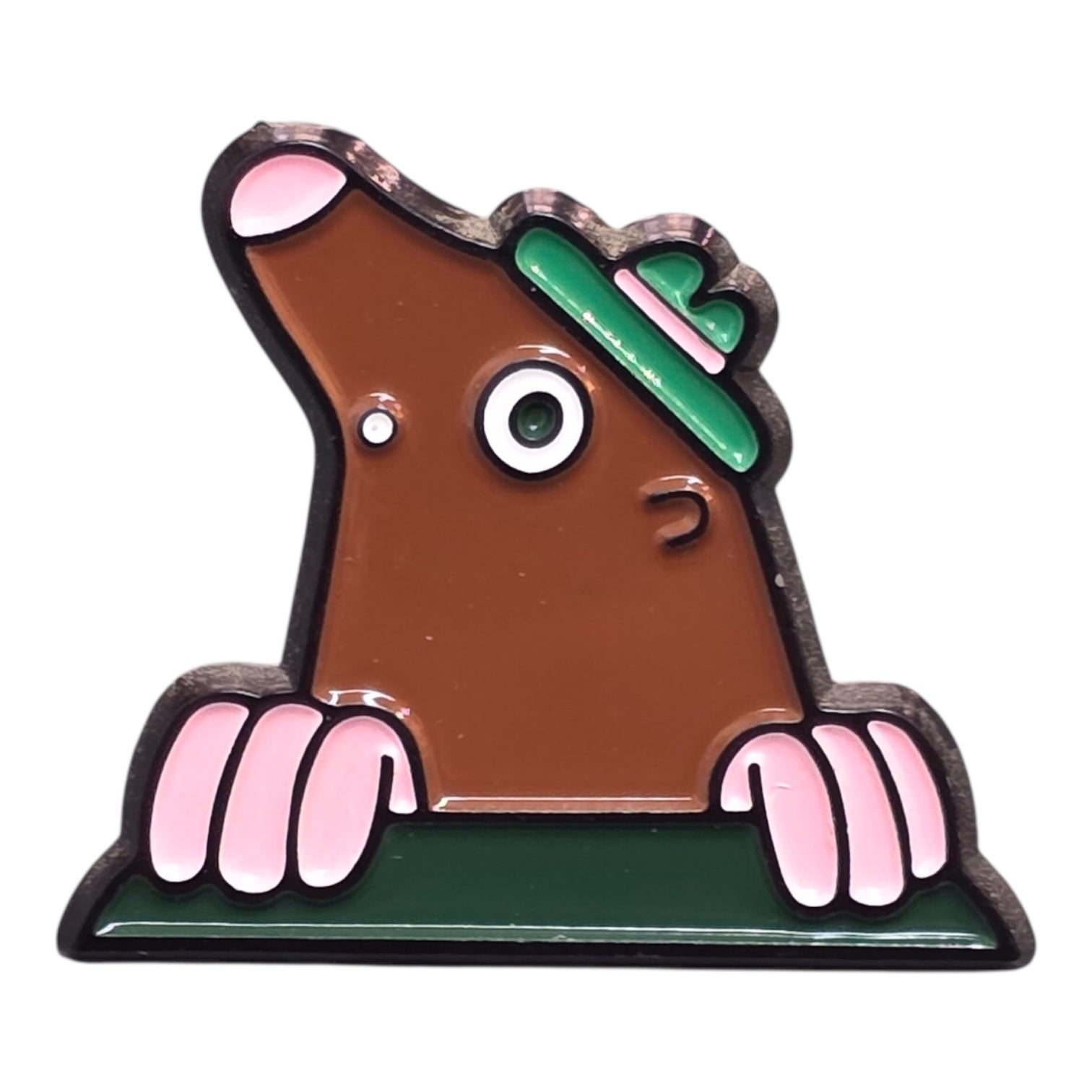 A close up of a mole shaped pin badge. 