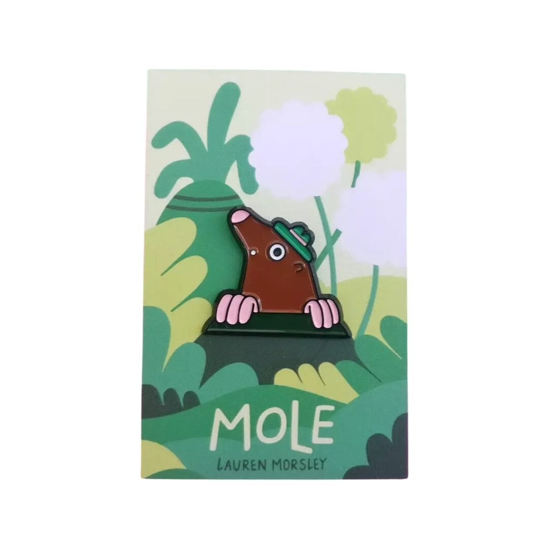 An image of a pin badge shaped like a mole. 