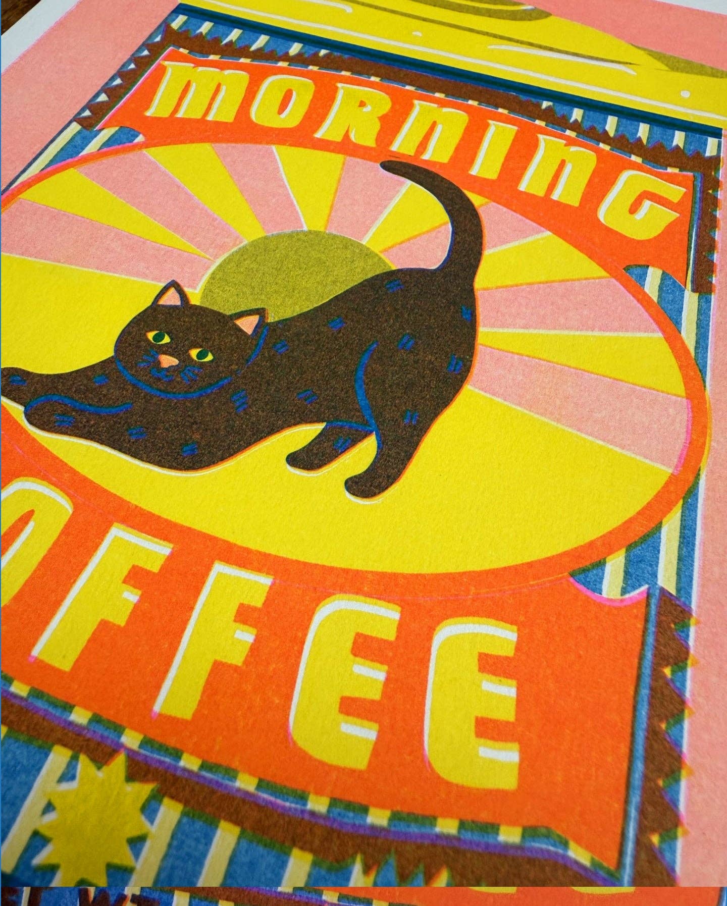 Colourful poster with a black cat and 'Morning Coffee' text on a yellow background.