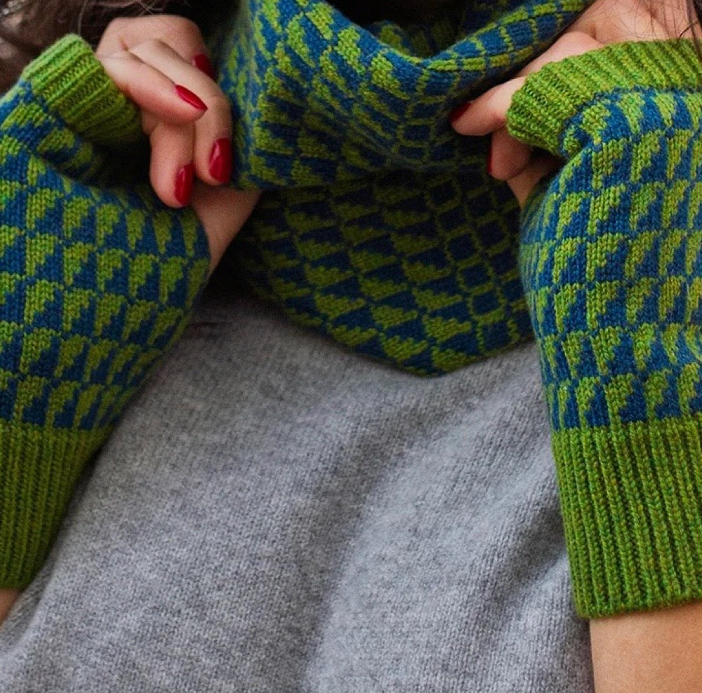 Close-up of green and blue patterned wrist warmers and snood being worn.