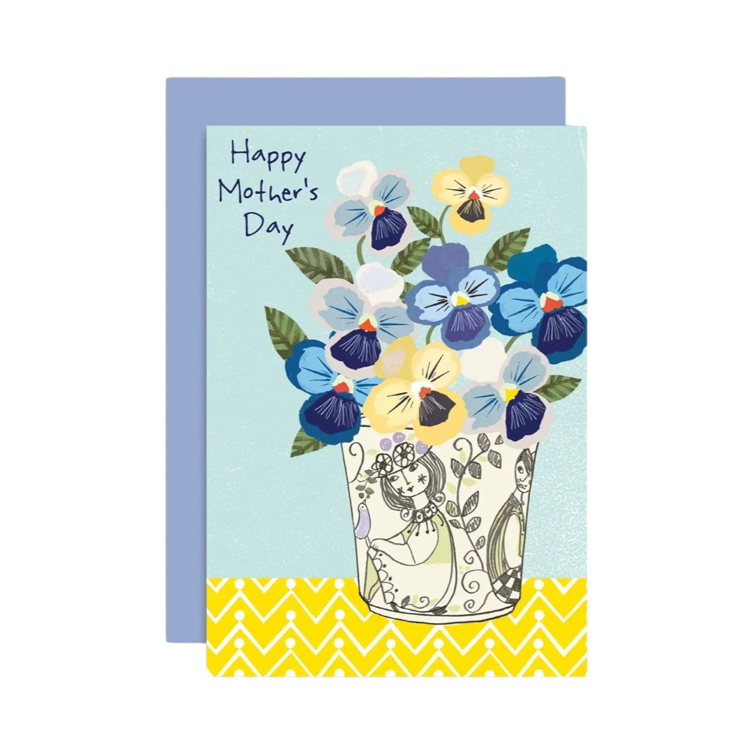 Mother's Day card featuring a bunch of blue, yellow and white pamsies in a white and grey vase with the text 'Happy Mother's Day'.