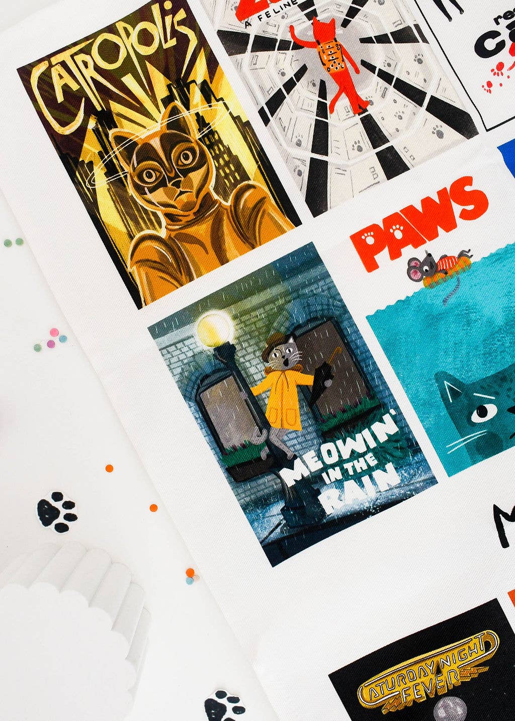 Close up of movie poster tea towel with cat themes.
