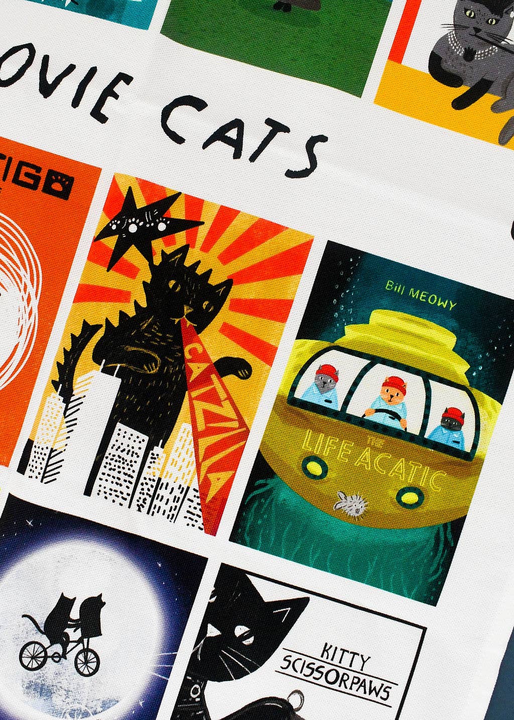 Close up of movie poster tea towel with cat themes.