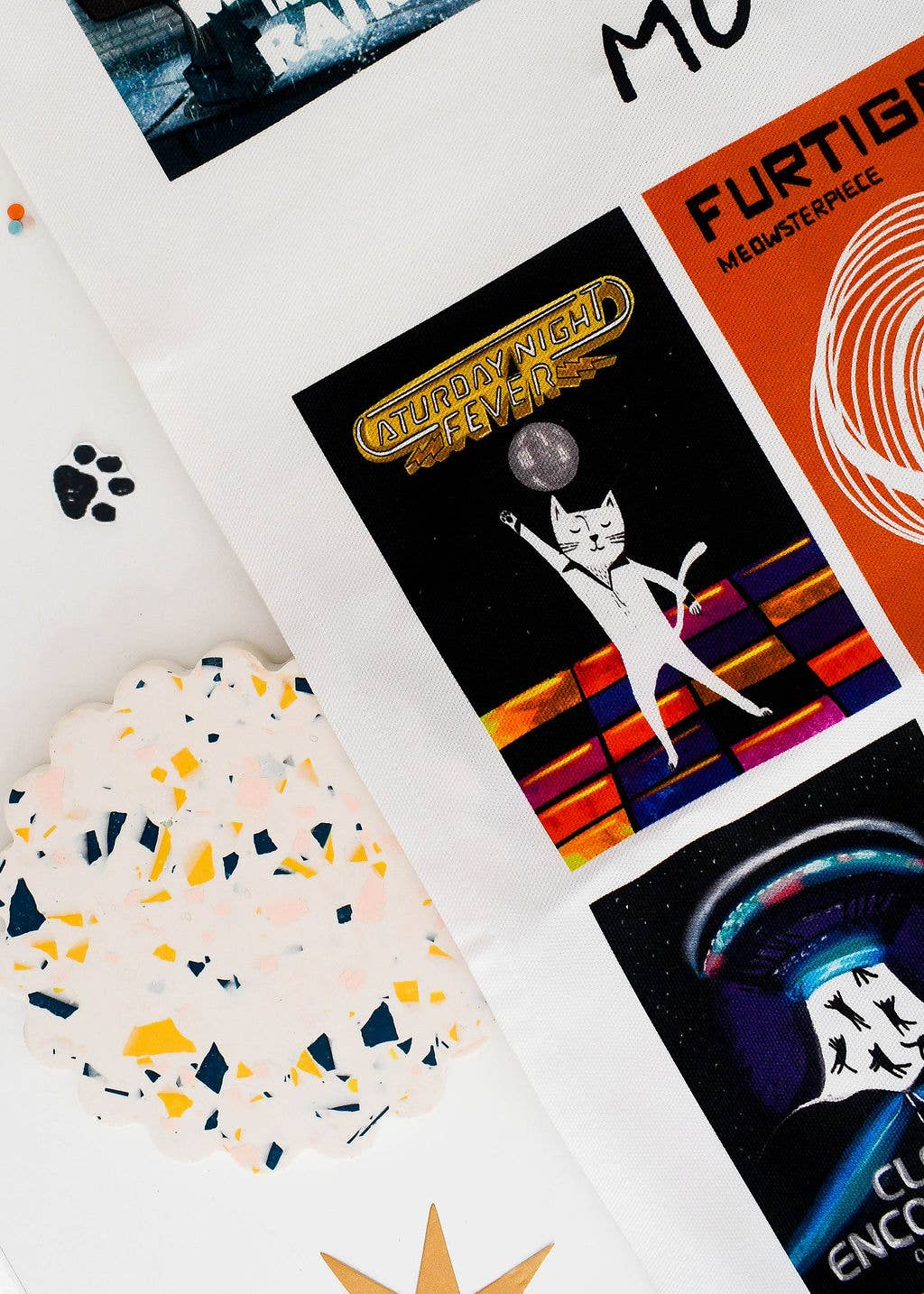 Close up of movie poster tea towel with cat themes.