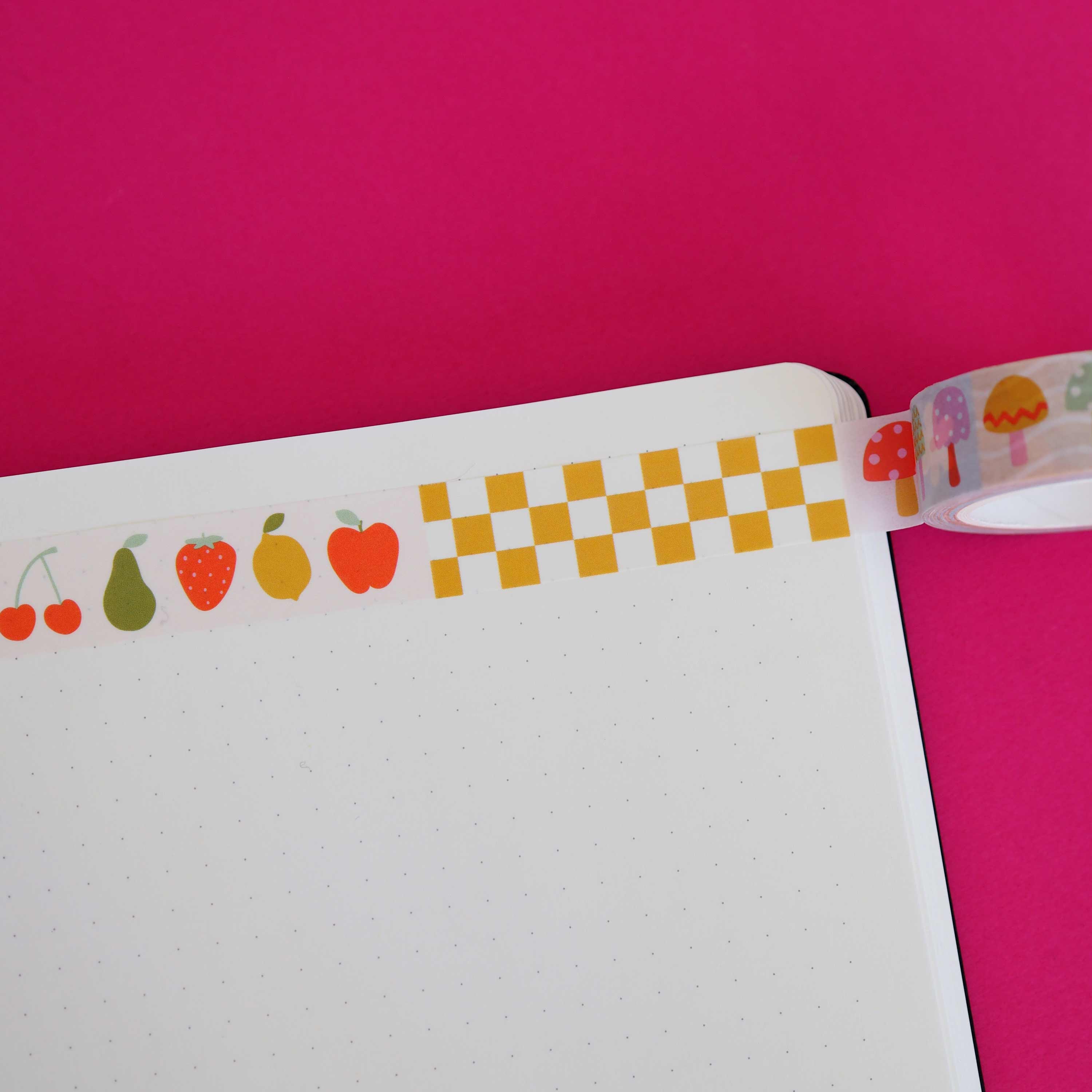 Fruit and checkered washi tape across a page.