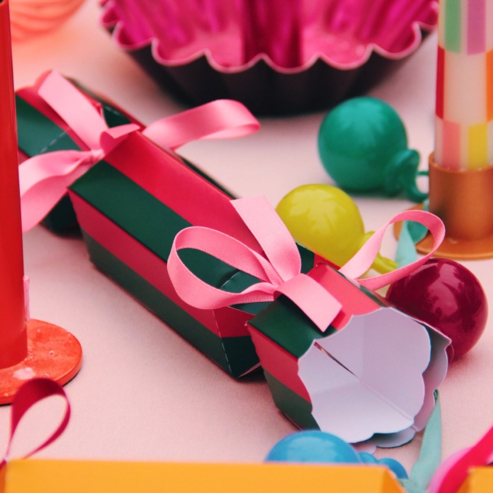 Colourful Christmas cracker on decorated table. 