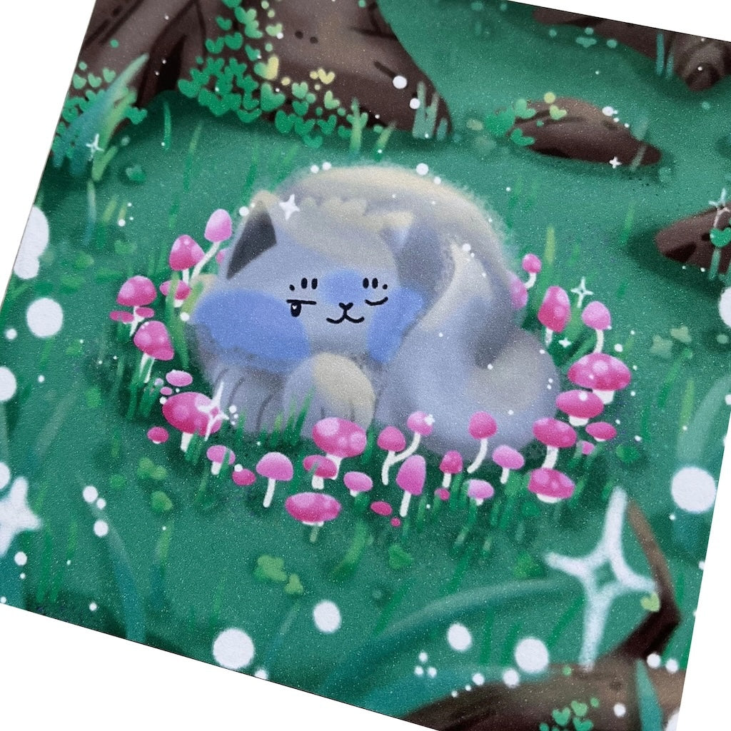 Illustrated print of a grey cat curled up inside a pink, mushroom, fairy circle in the middle of a forest. Includes white sparkle details.