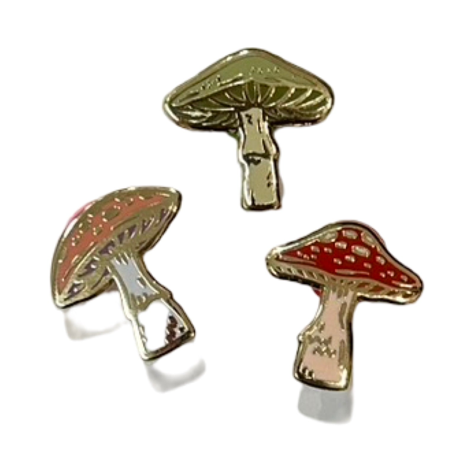 Mushroom-shaped earrings with red caps and gold bodies on a white background.