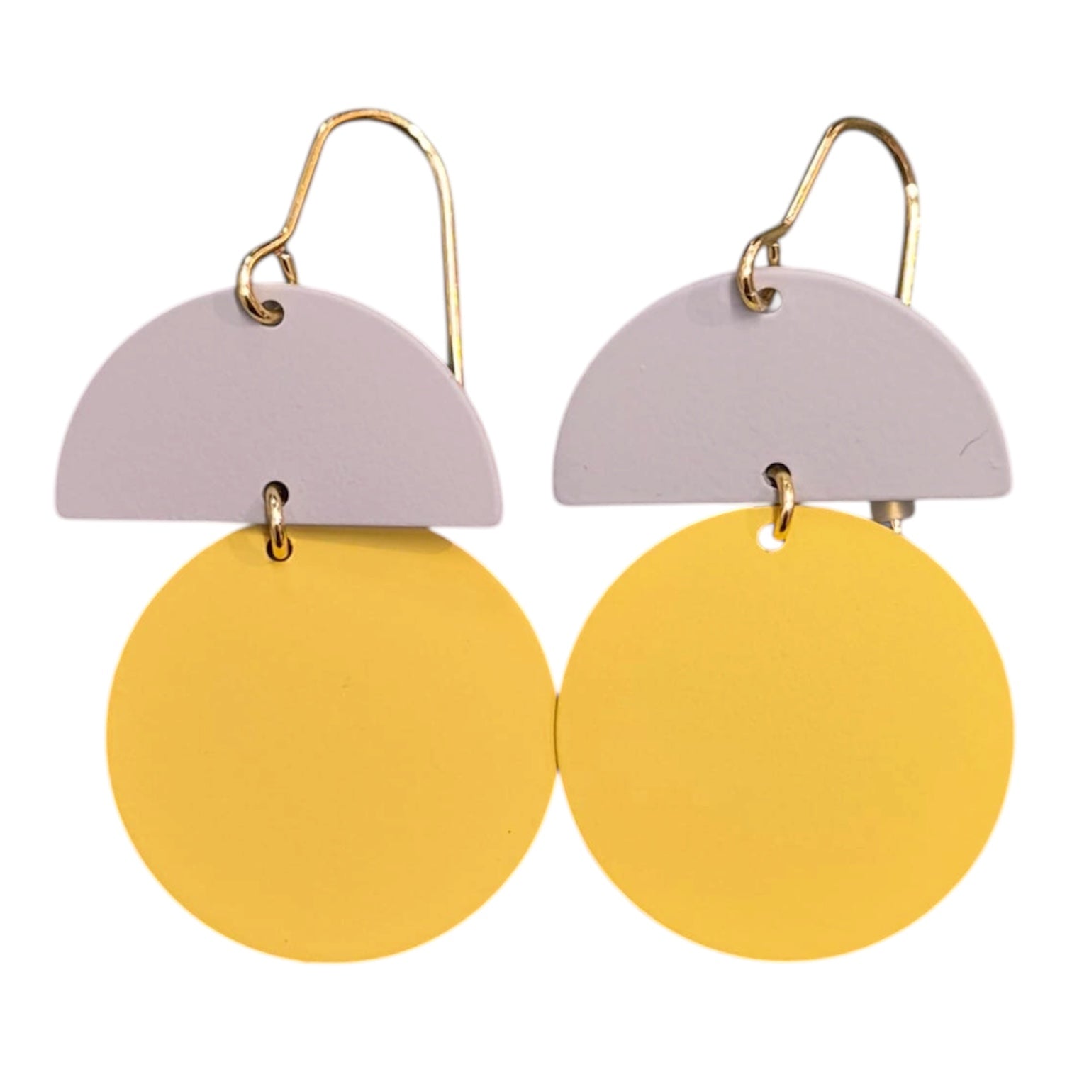 Earrings with half-circle and mustard round design on a white background.