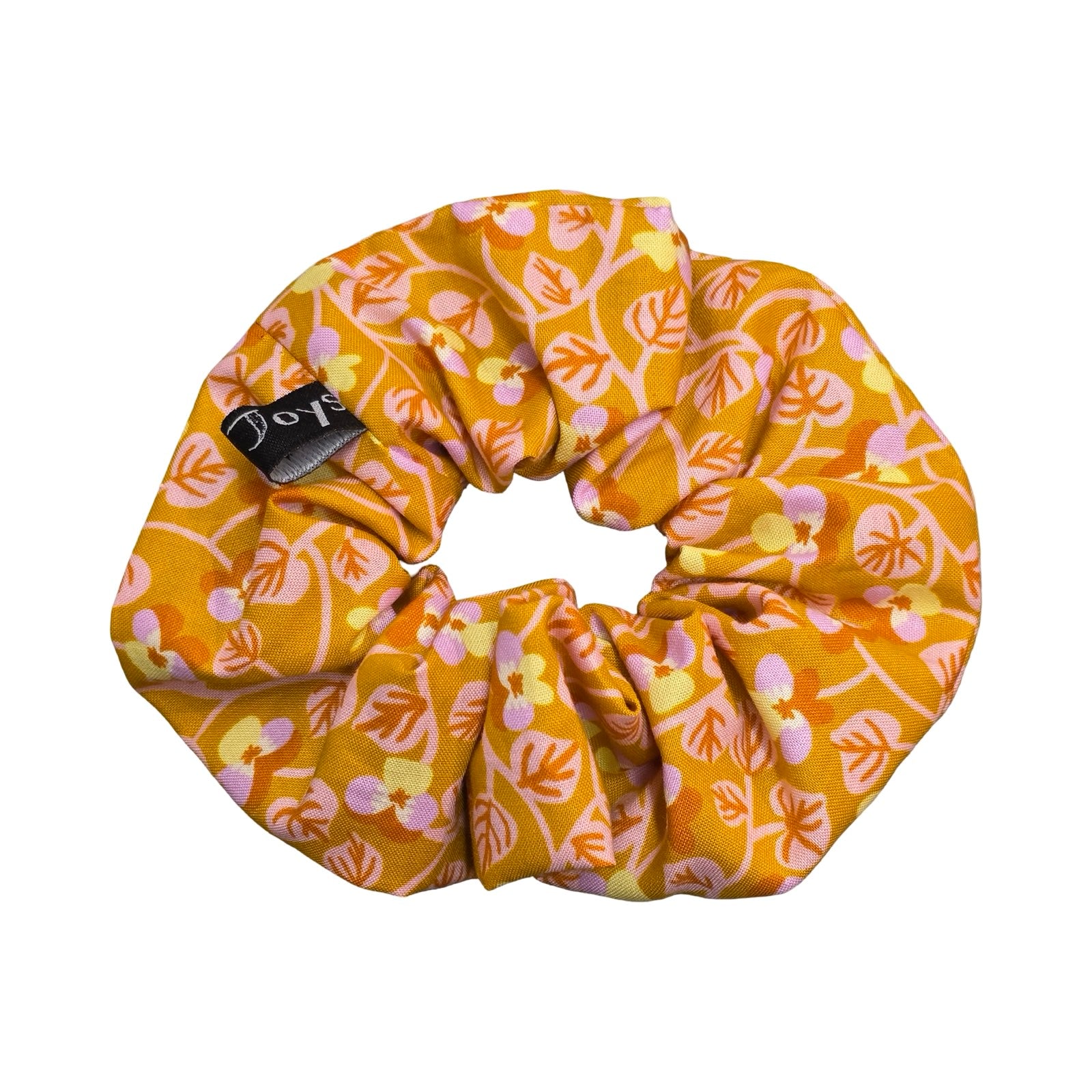 This mustard handmade hair scrunchie is made from 100% cotton fabric with small lilac and yellow violets and pale pink leaves.