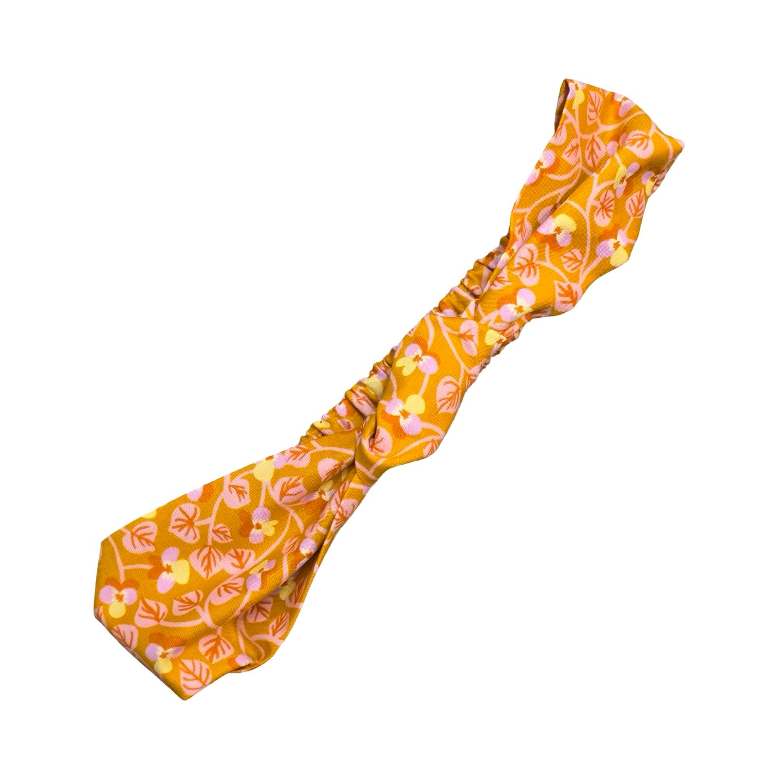 This handmade mustard floral knotted headband is made from 100% cotton fabric with small lilac and yellow violets and pale pink leaves.