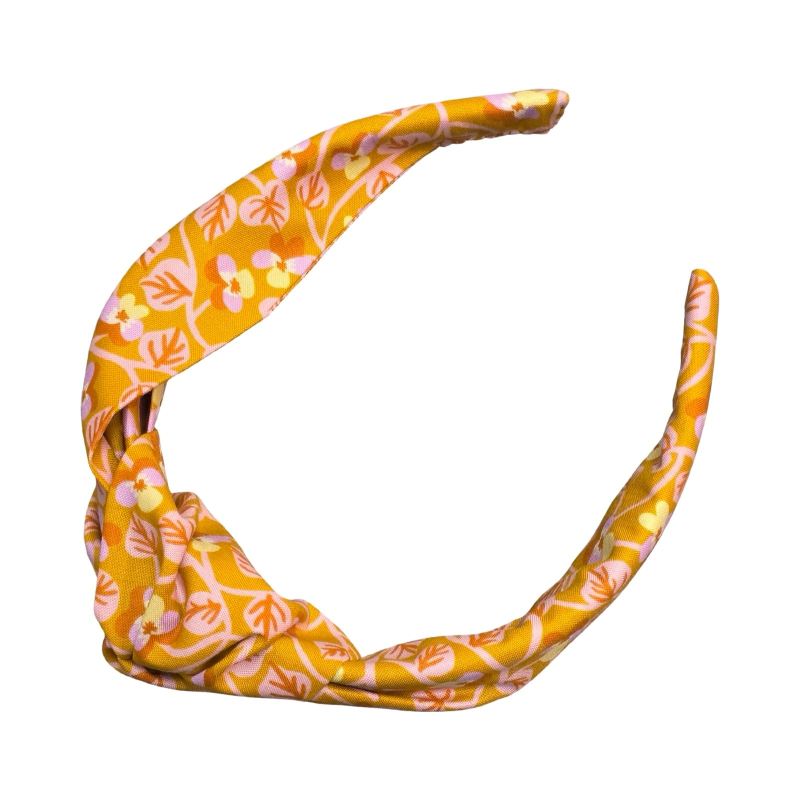 This mustard handmade floral top-knot Alice band is made from 100% cotton fabric with small lilac and yellow violets and pale pink leaves. 