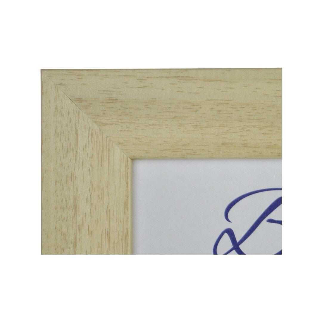 the corner detail of a natural wood picture frame