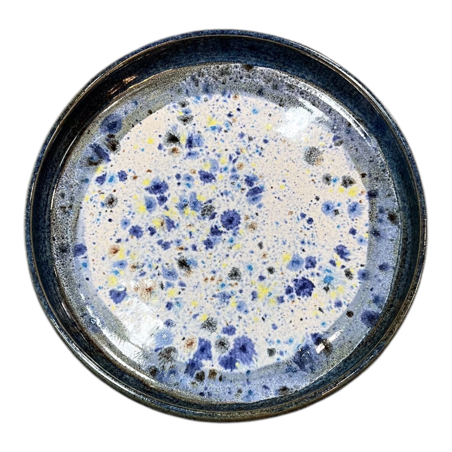 Photo of a ceramic para bowl from above, with speckled centre and navy blue sides.