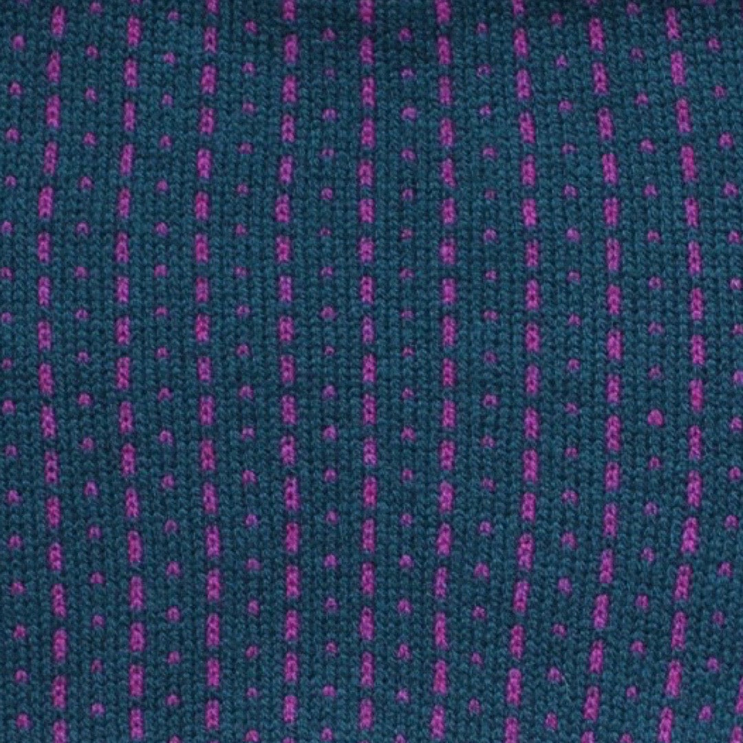 A cosy 100% lambswool knitted snood in navy with magenta dashes.