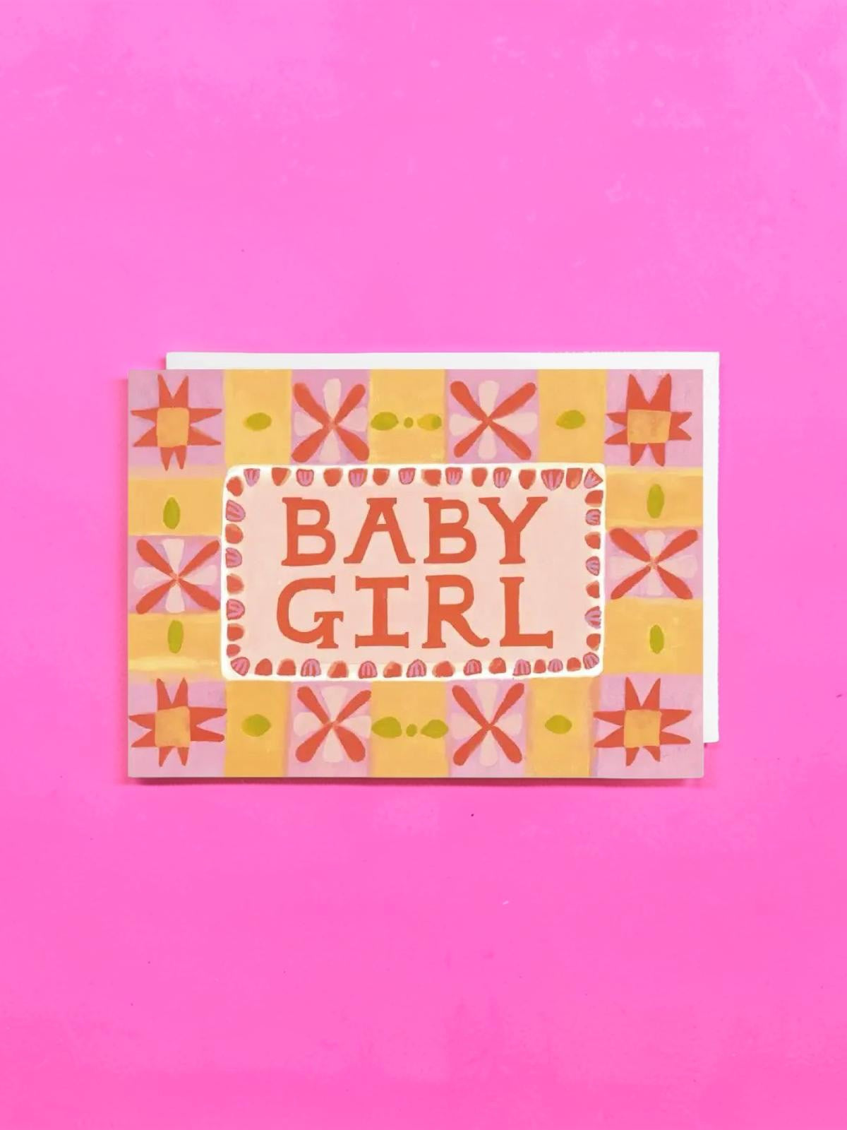Greeting card with 'Baby Girl' text on a pink background.