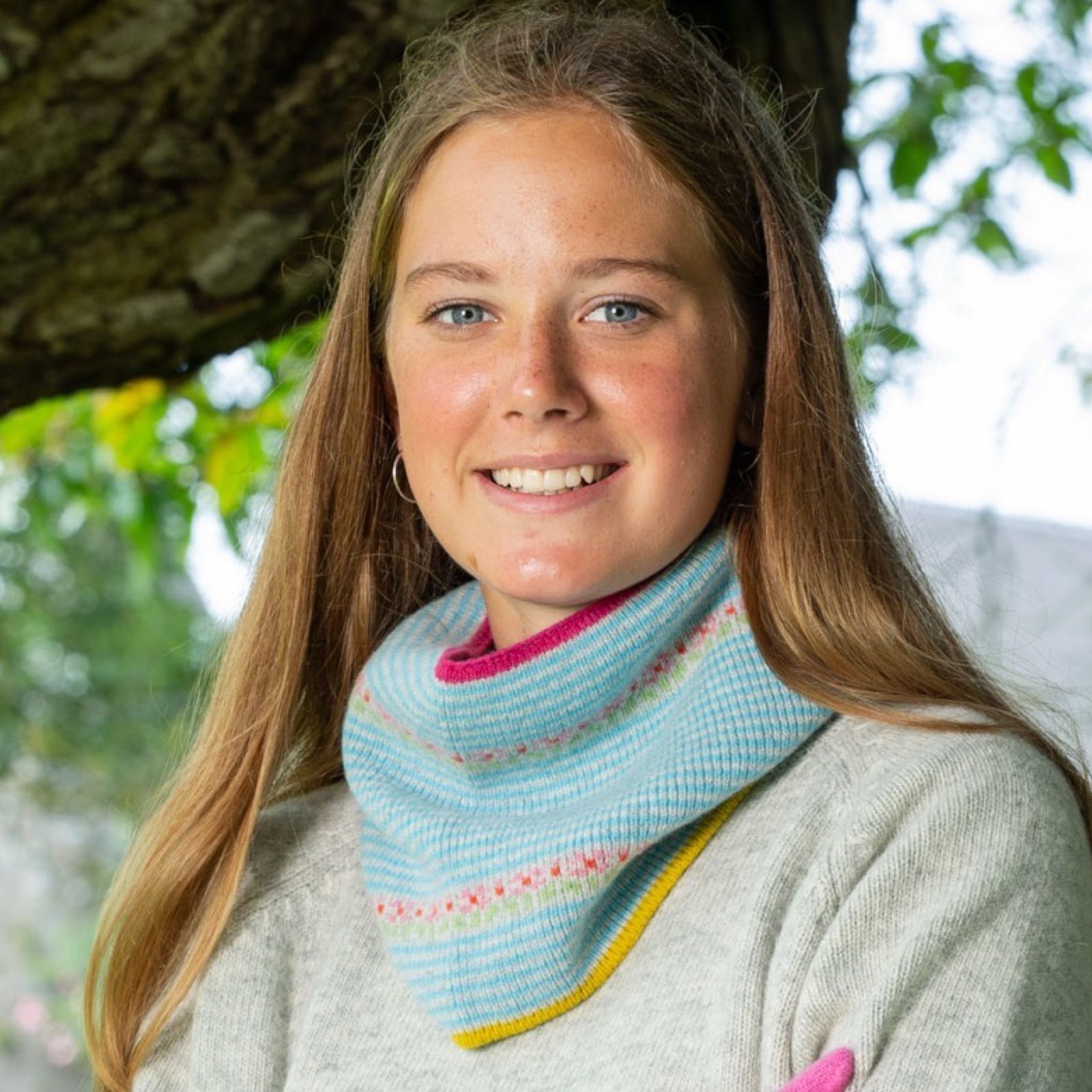 Woman wearing a colorful knitted snood.