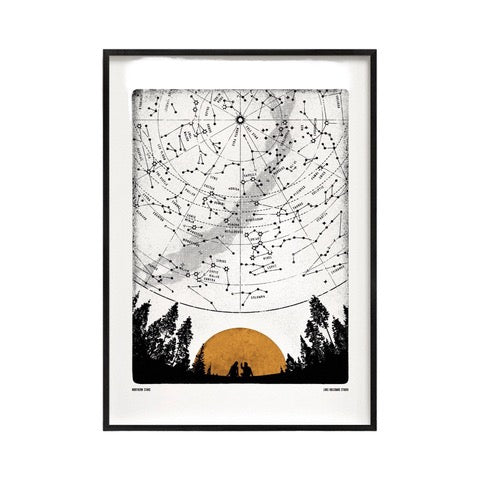Black and white print featuring the northern lights mapped out in the sky, and a mustard-coloured sun setting behind the mountains. 