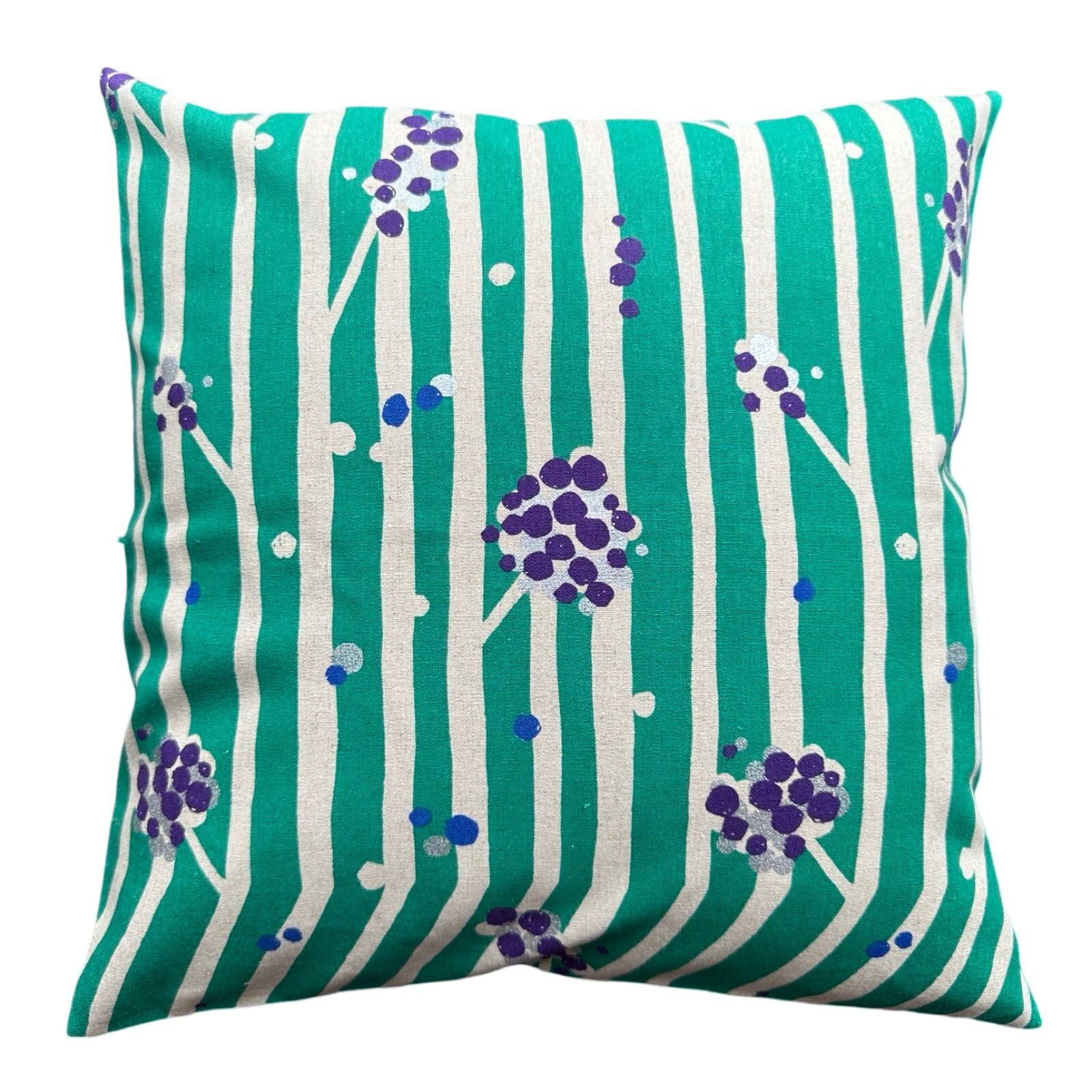 A cushion cover with green and white stripes, featuring white branches with clusters of purple nuts.