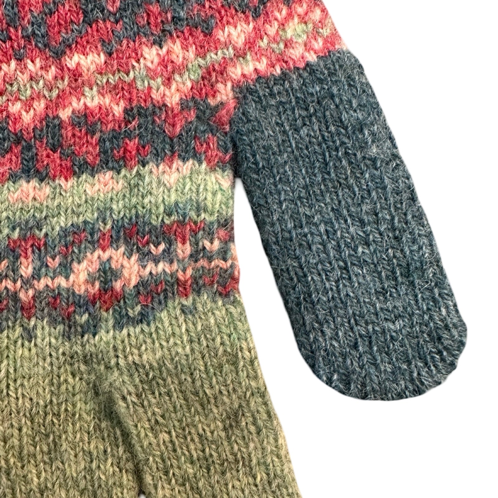 Close-up of a knitted gloves with multicolored pattern on a white background.