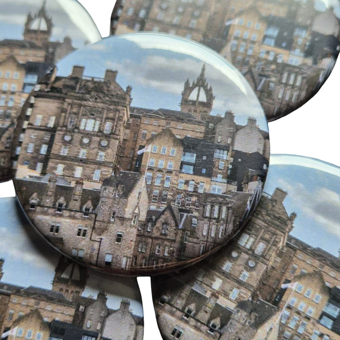 A close up of a magnet with a picture of old buildings on it. 
