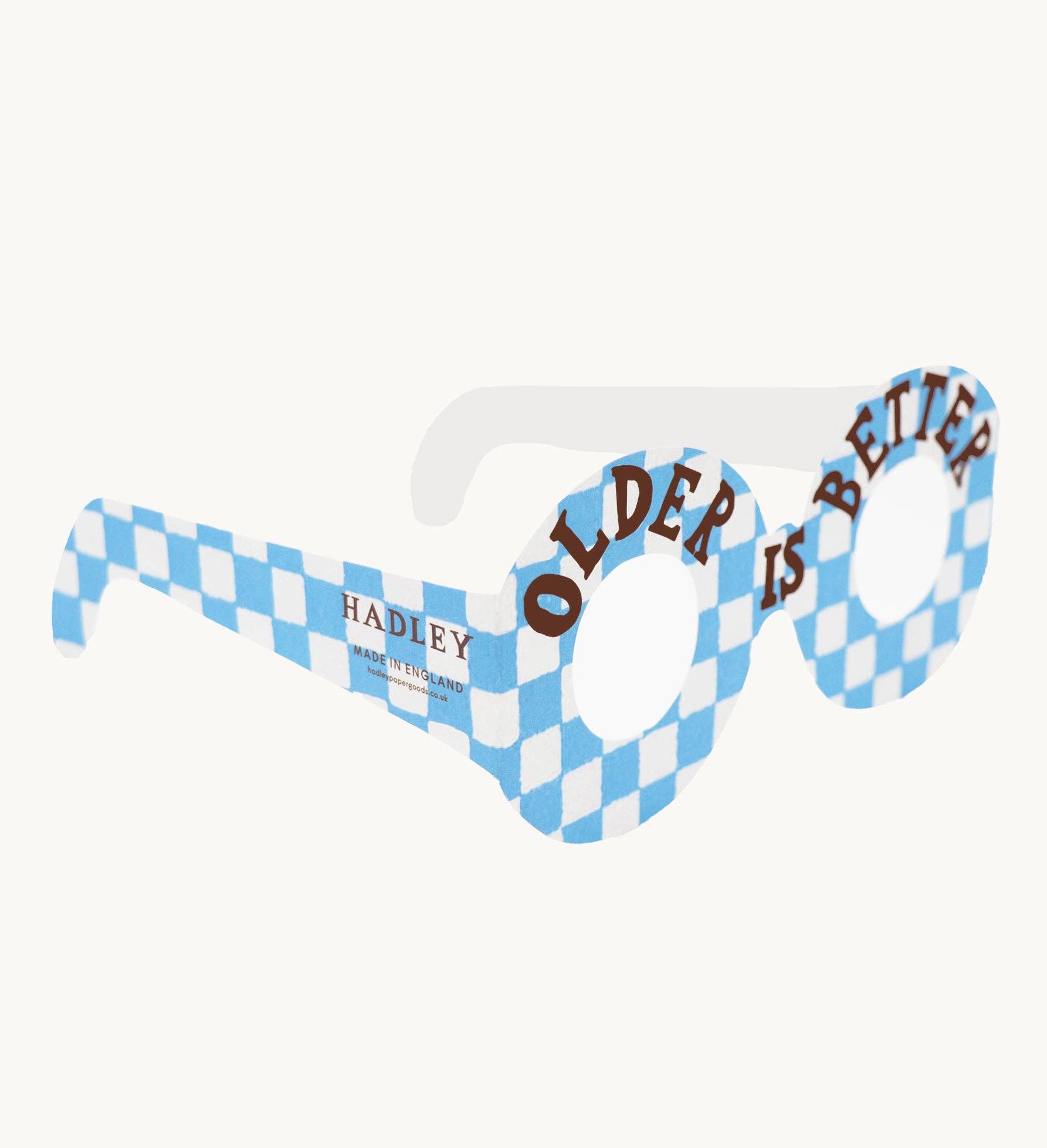 Novelty sunglasses with blue and white checkered frame and 'Older is Better' text on a white background.