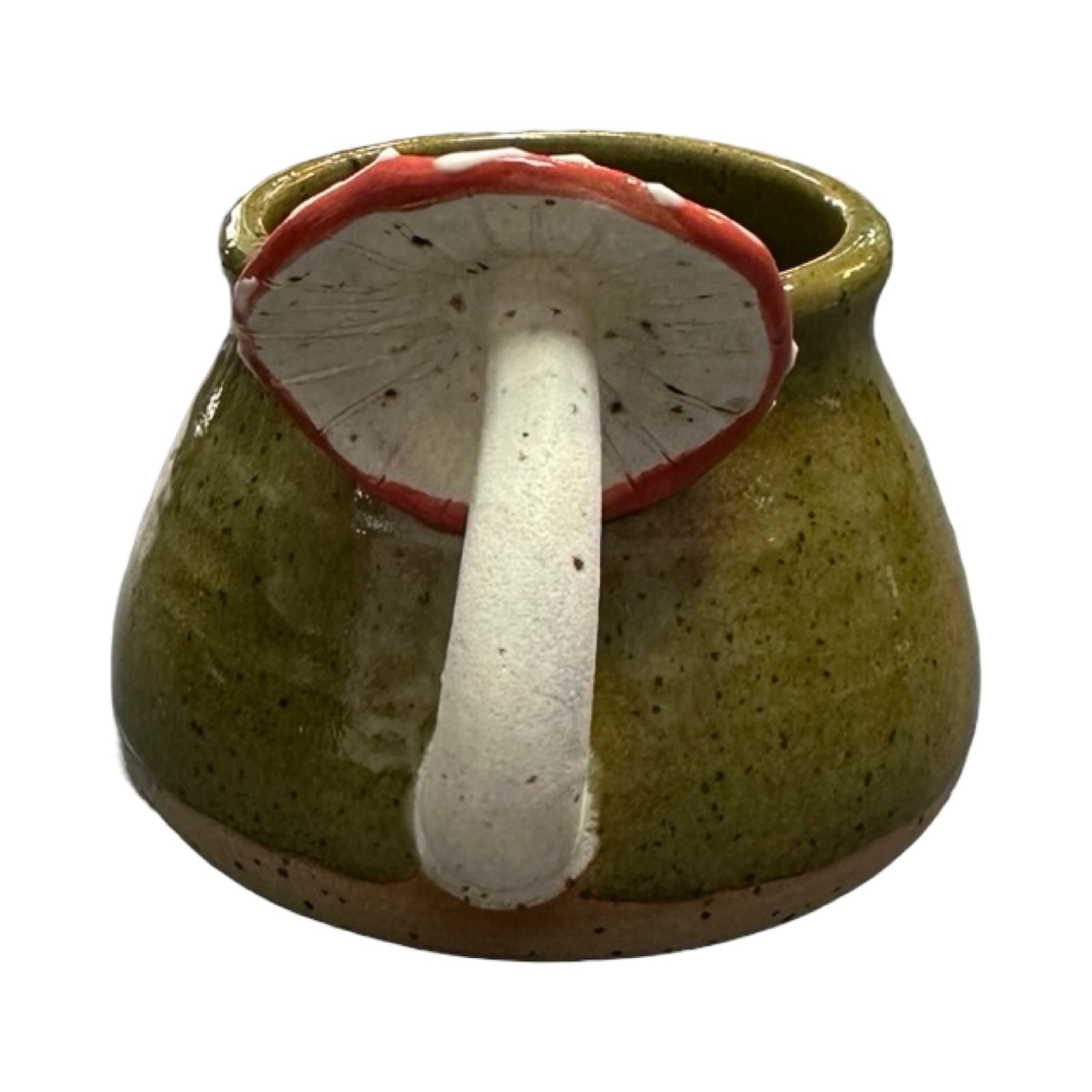 Ceramic mug with a red cap mushroom handle on a white background.