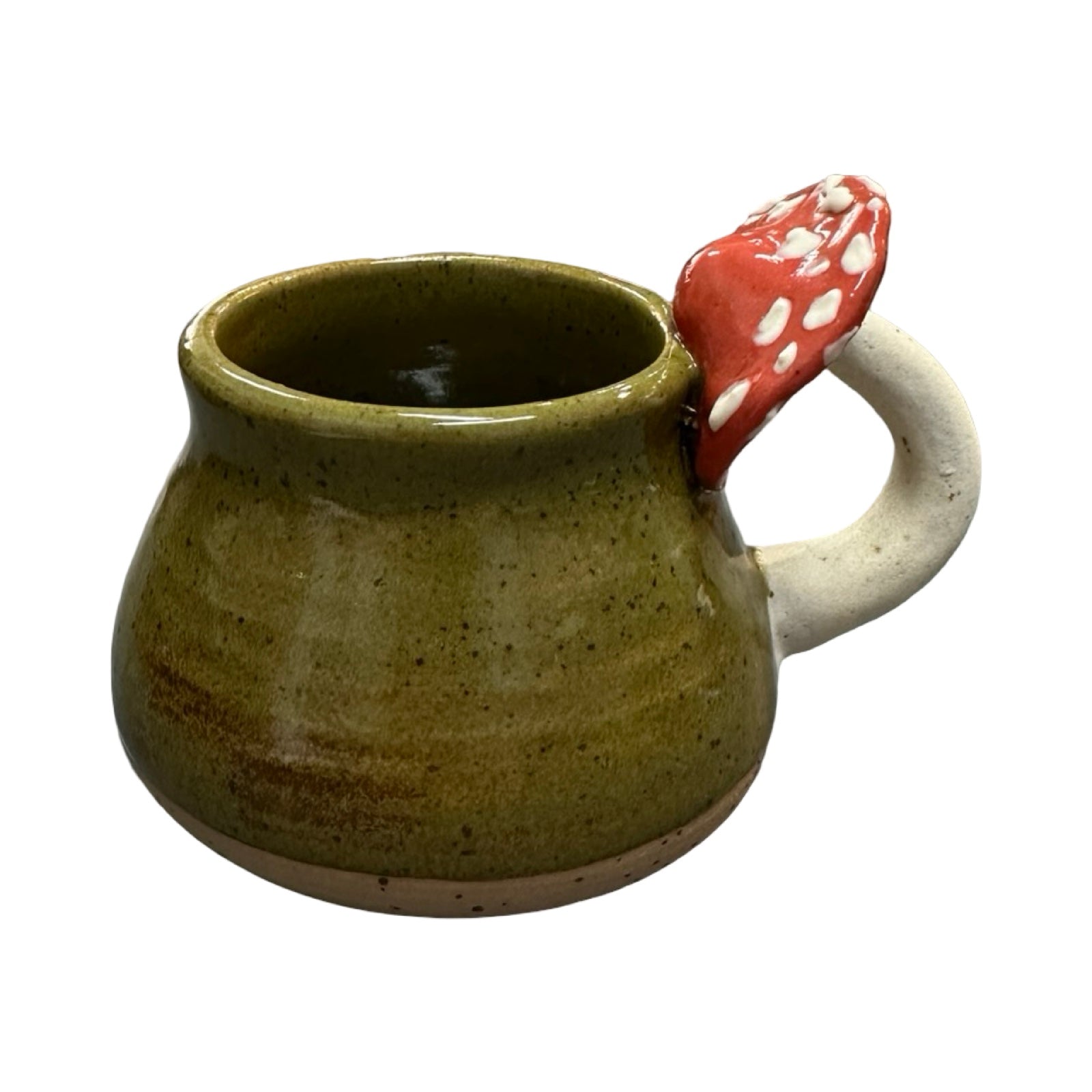 Green ceramic mug with a red mushroom handle on a white background.
