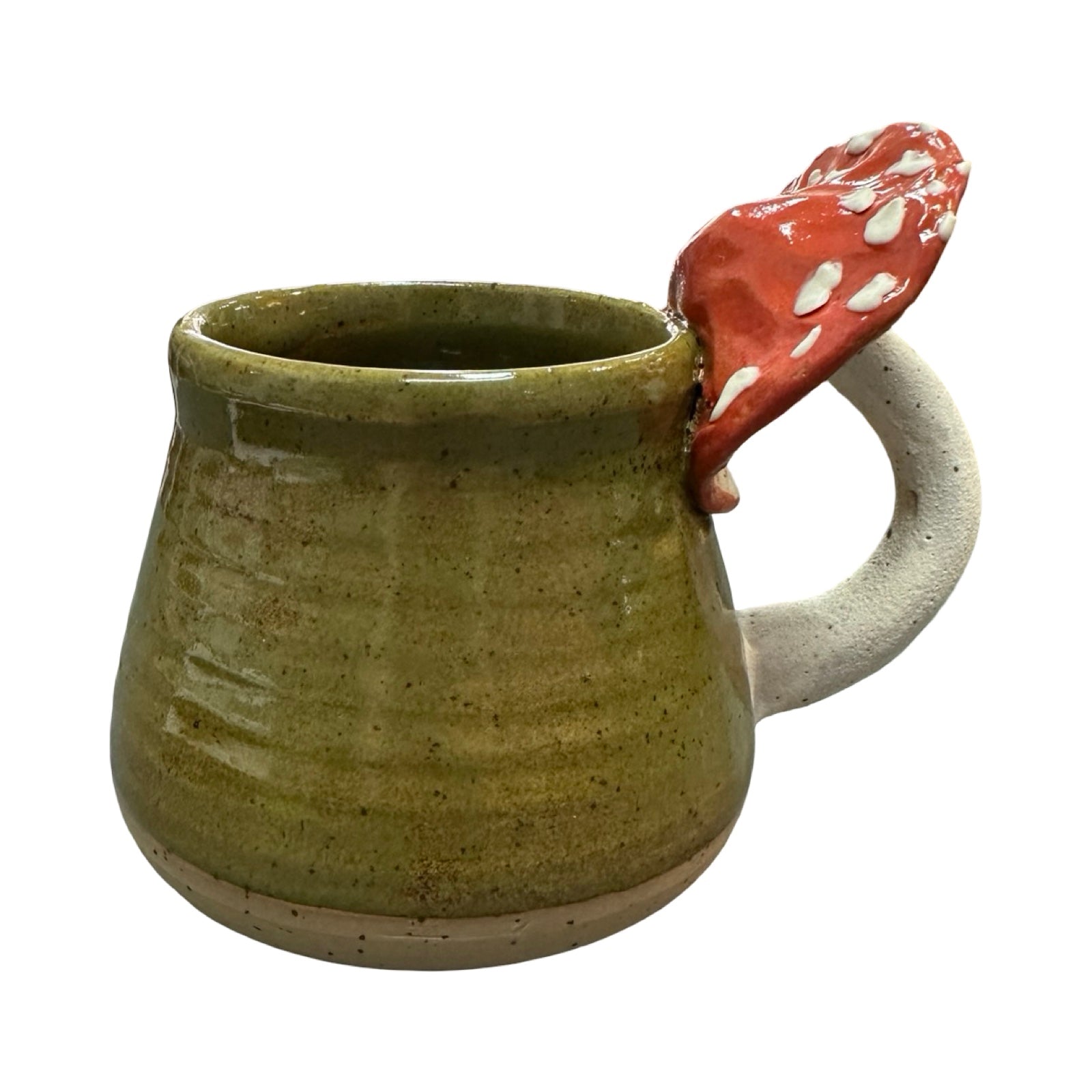Green ceramic mug with a red and white mushroom handle on a white background.