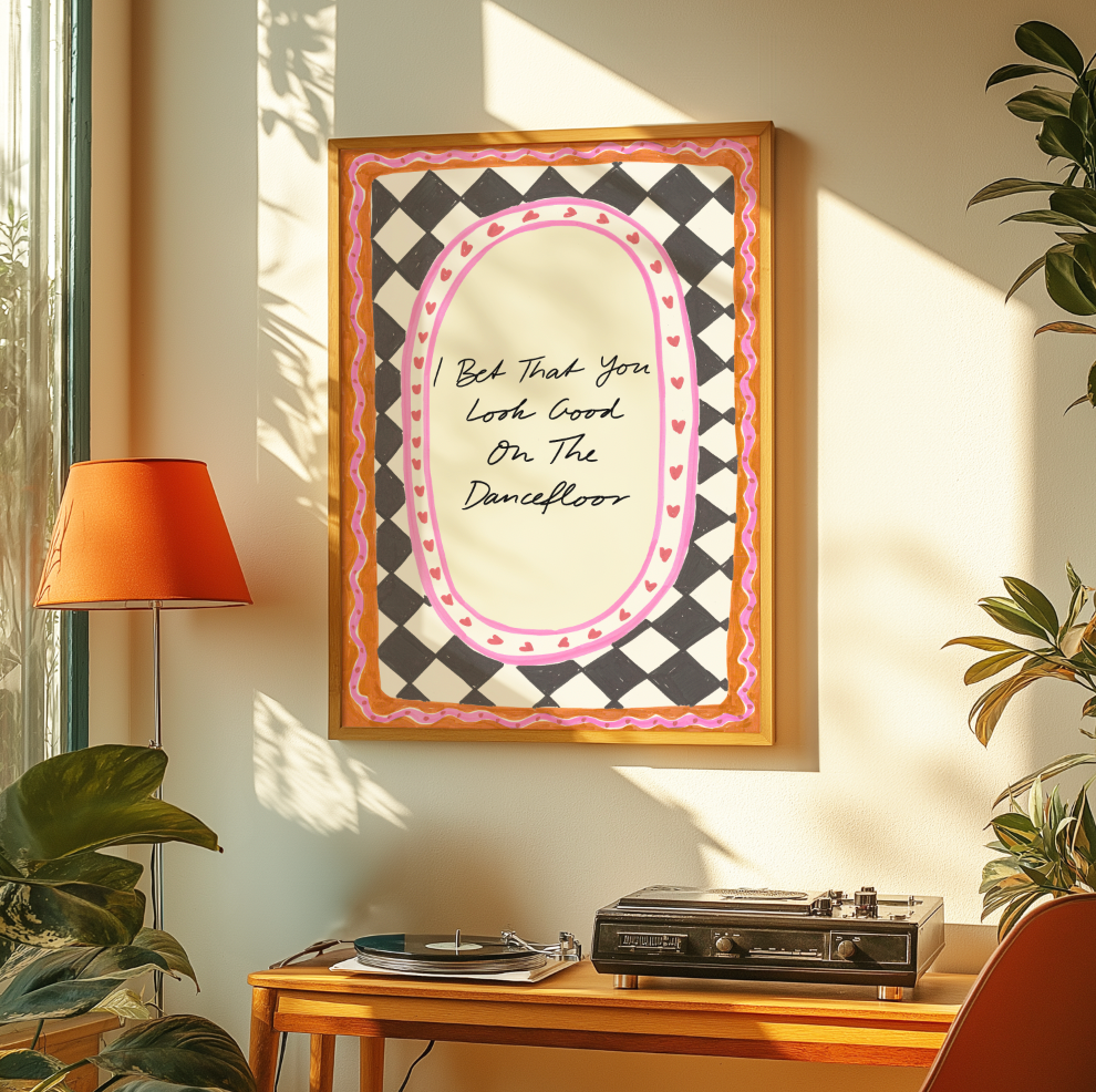 Framed artwork with decorative text on a wall above a record player.