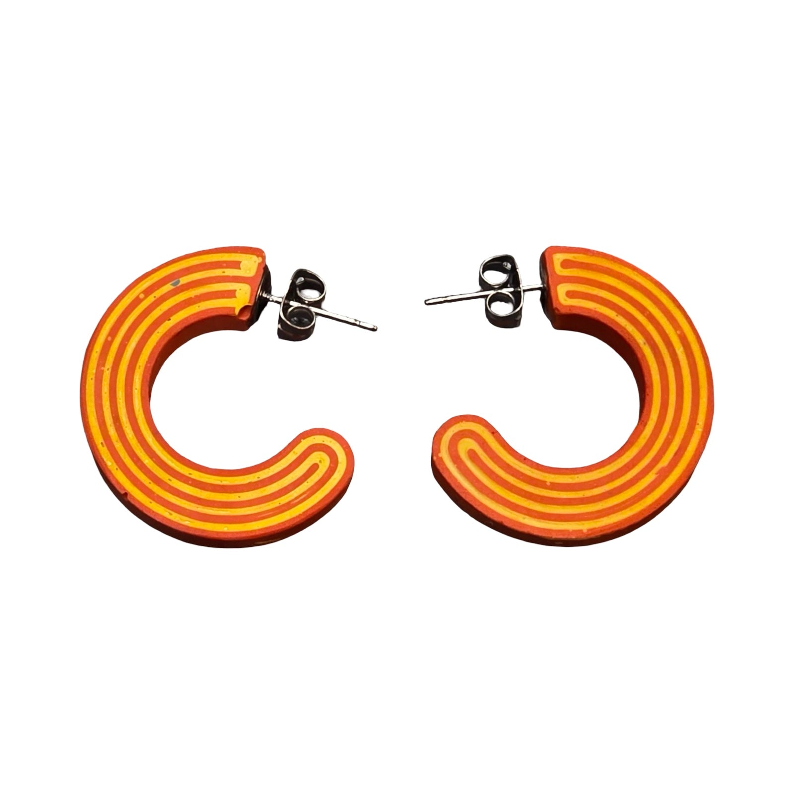 Orange chunky hoop earrings with red stripes.