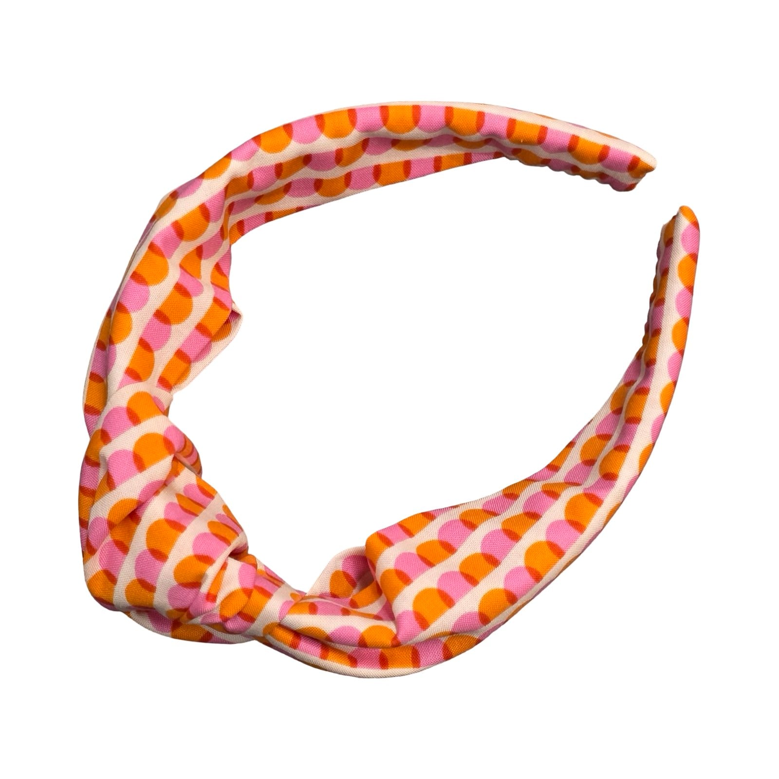This handmade floral top-knot Alice band is made from 100% cotton fabric with an orange and pink scalloped pattern. 