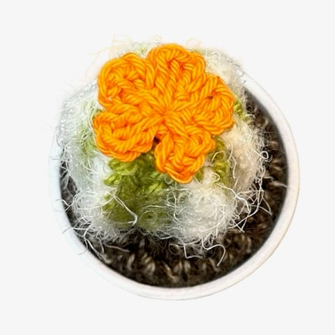 Handmade tall crochet cactus with an orange flowers. 