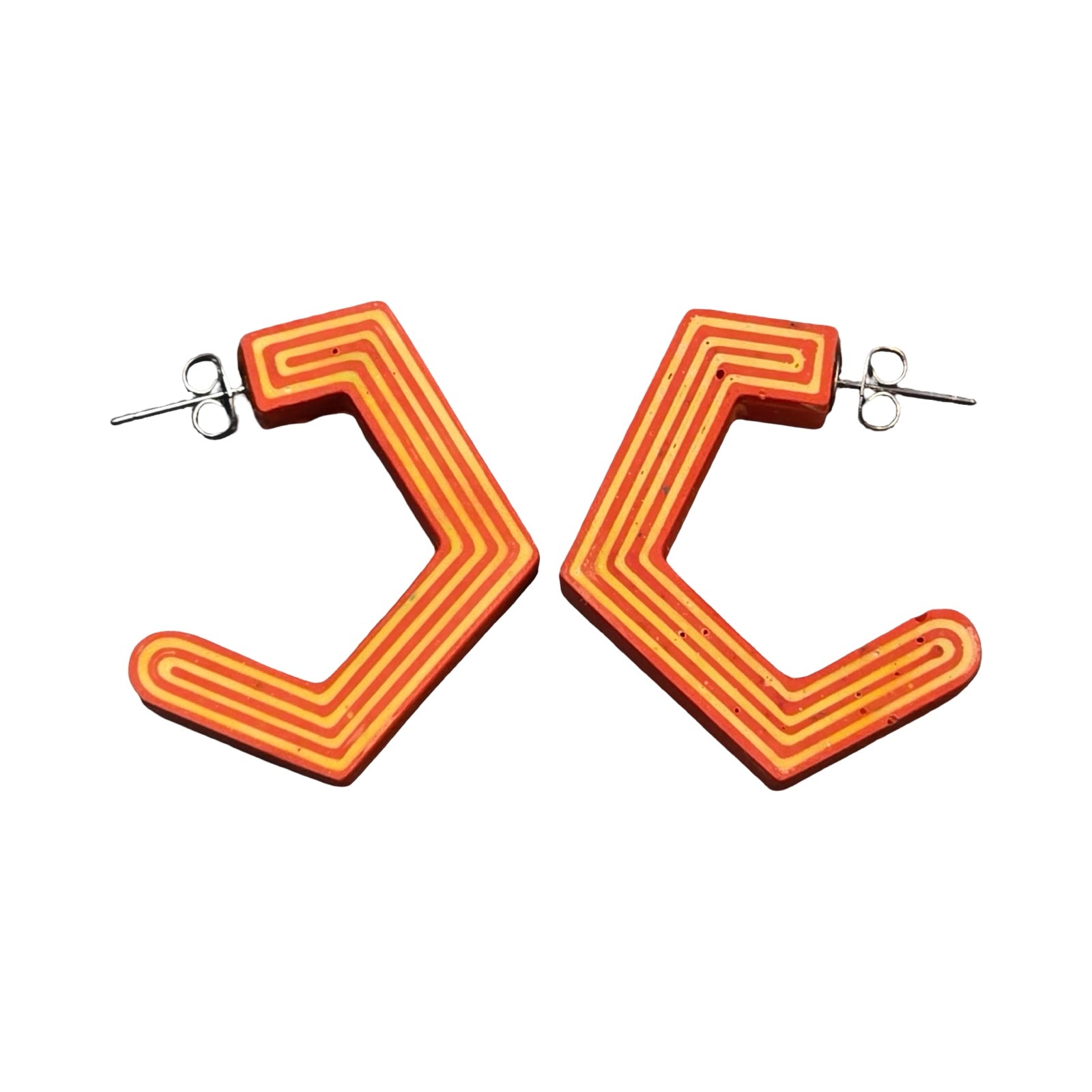 Orange chunky hexagon hoop earrings with yellow stripes.