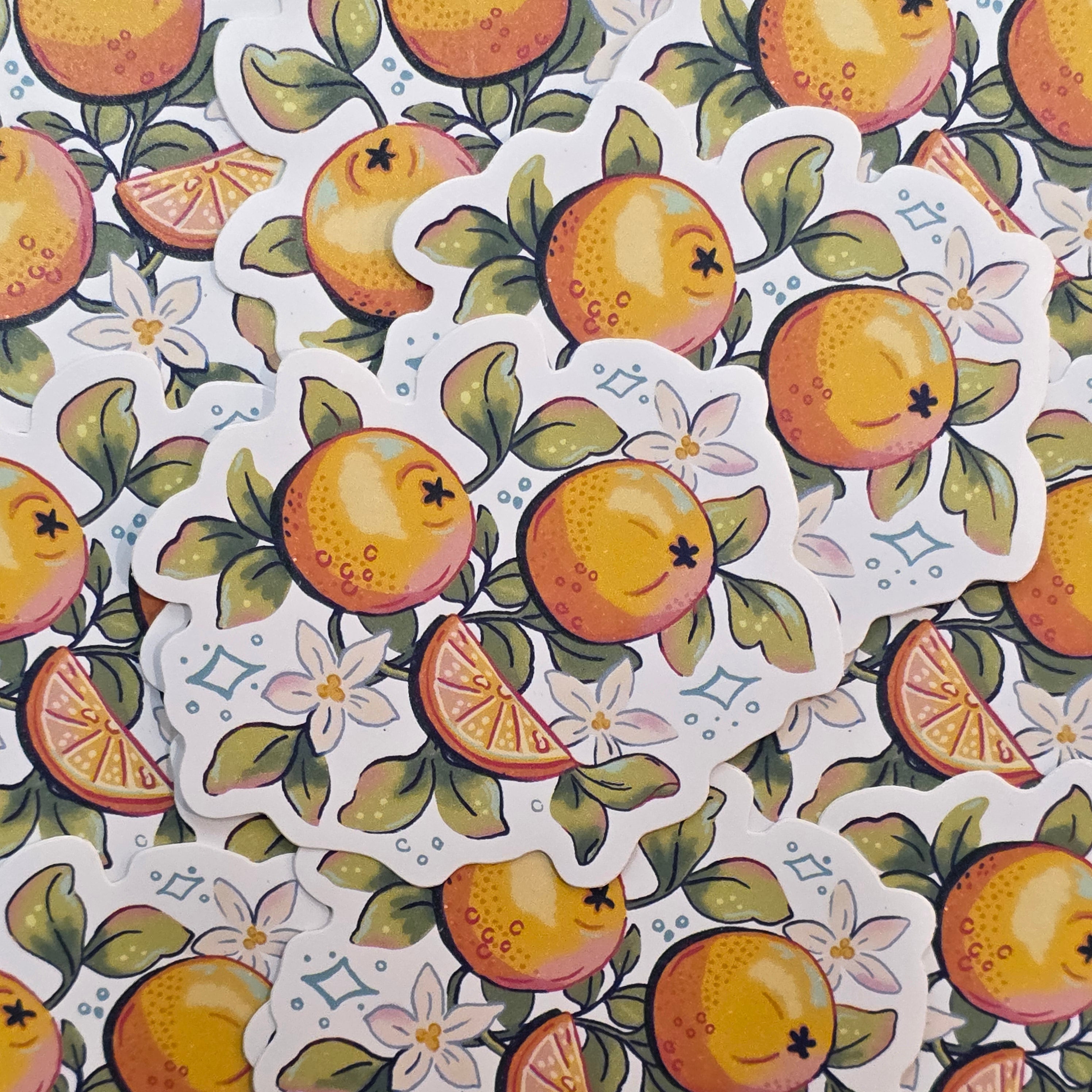 Sticker featuring an illustration of a group of oranges surrounded by green leaves.